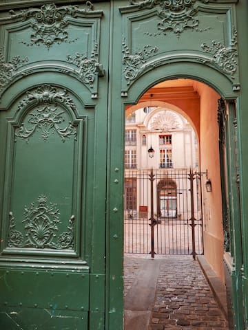 a green gate with a door open