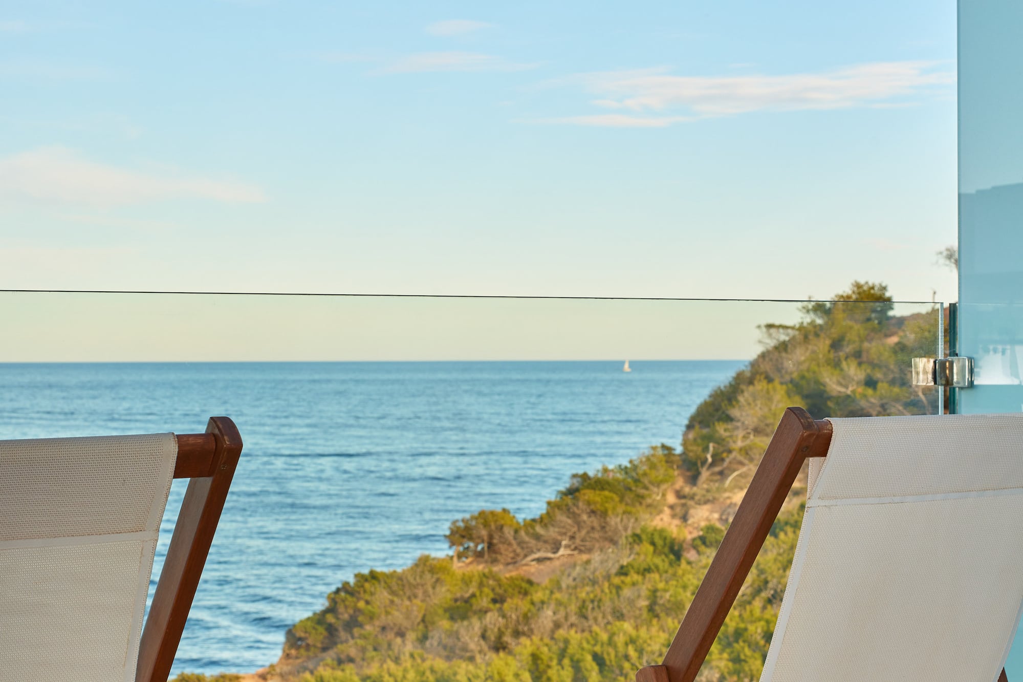 chairs on a balcony overlooking the ocean