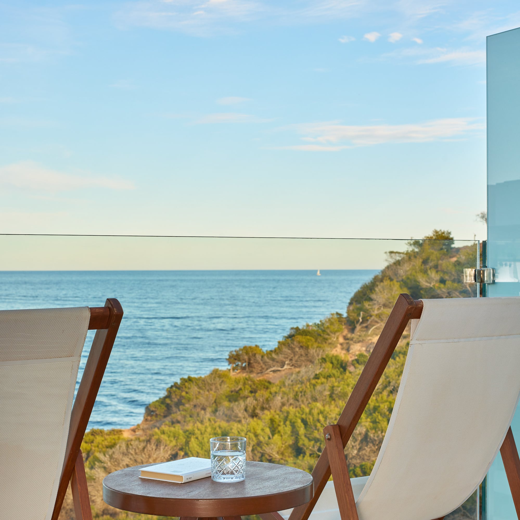 chairs on a balcony overlooking the ocean