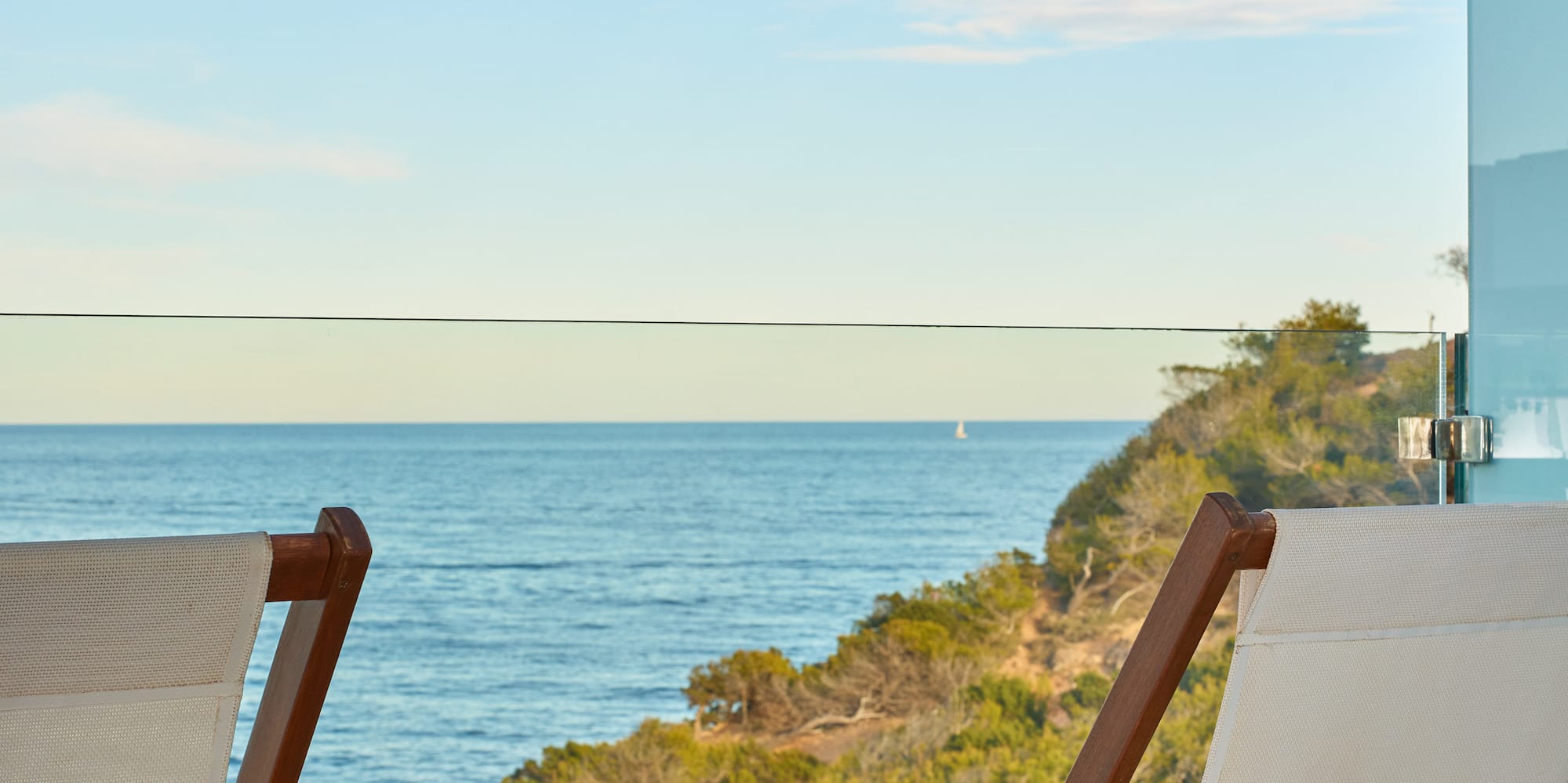 chairs on a balcony overlooking the ocean
