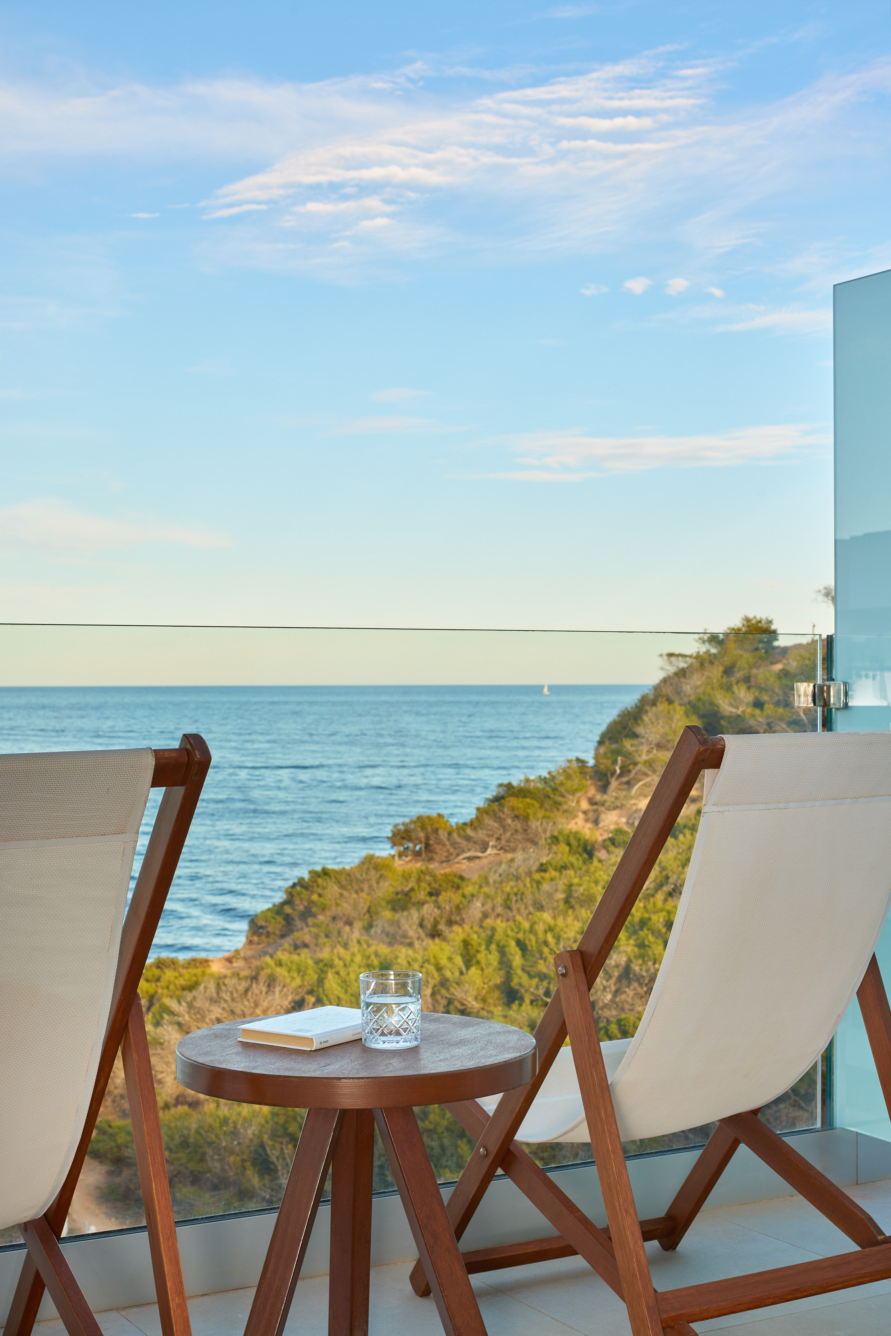 chairs on a balcony overlooking the ocean