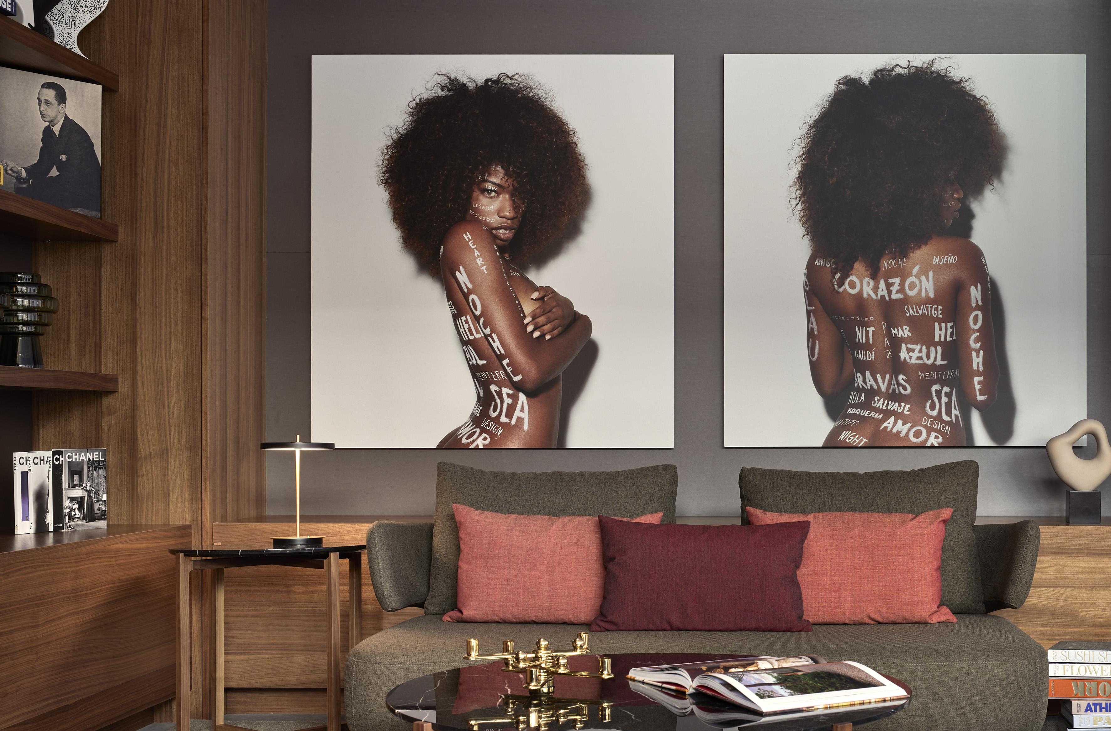 Contemporary living room with sofa, wood panels, and artistic wall prints.
