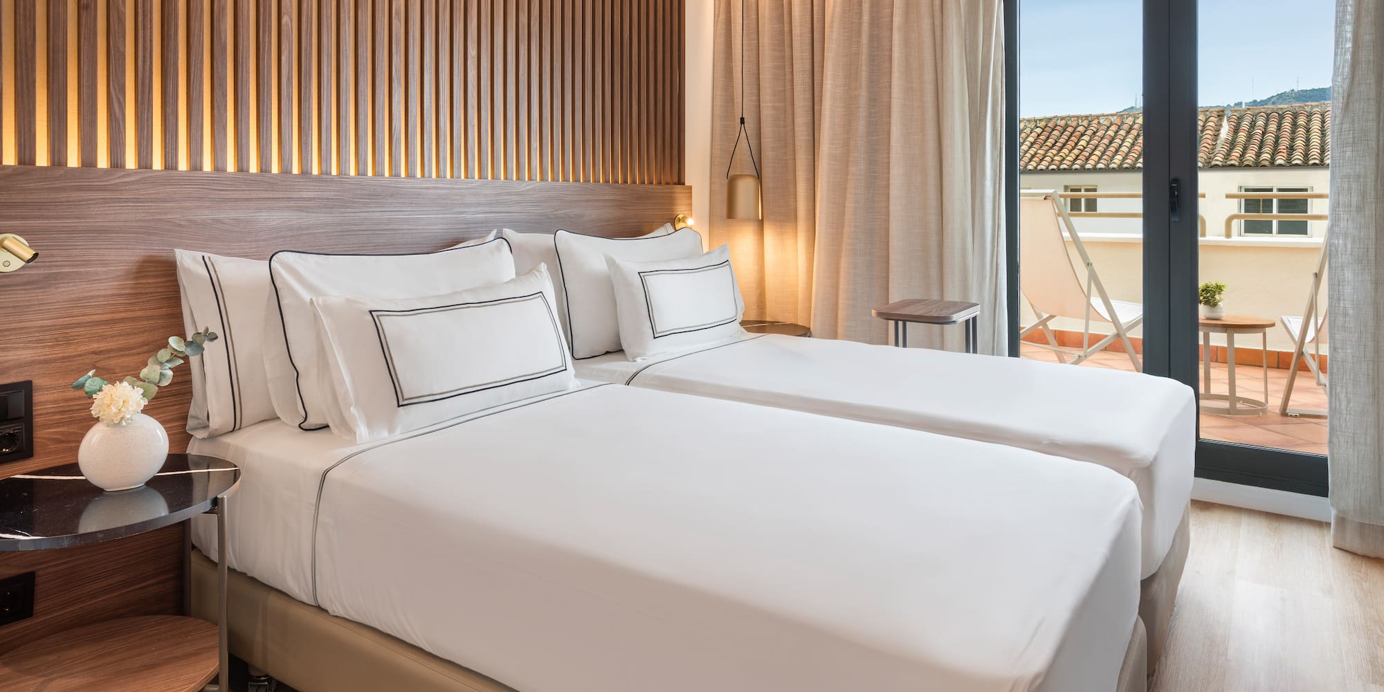 a room with two beds and a glass door