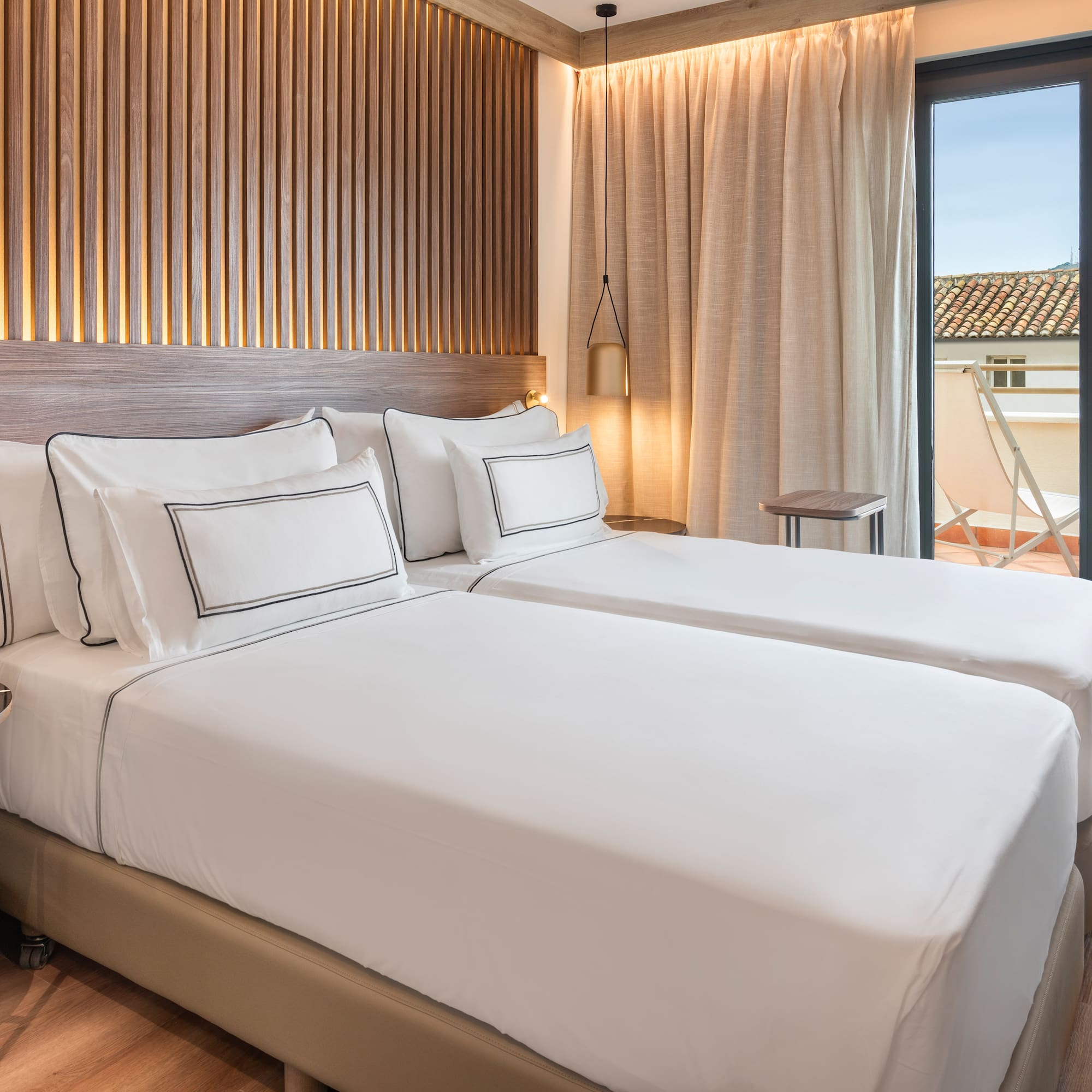 a room with two beds and a glass door