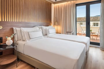 a room with two beds and a glass door