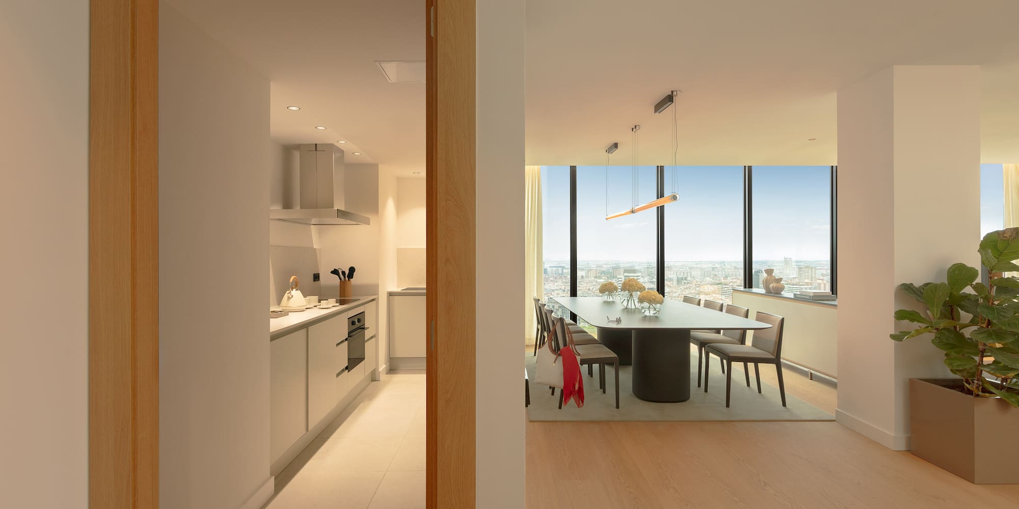 Modern high-rise apartment: open-plan dining room with city view, sleek kitchen.