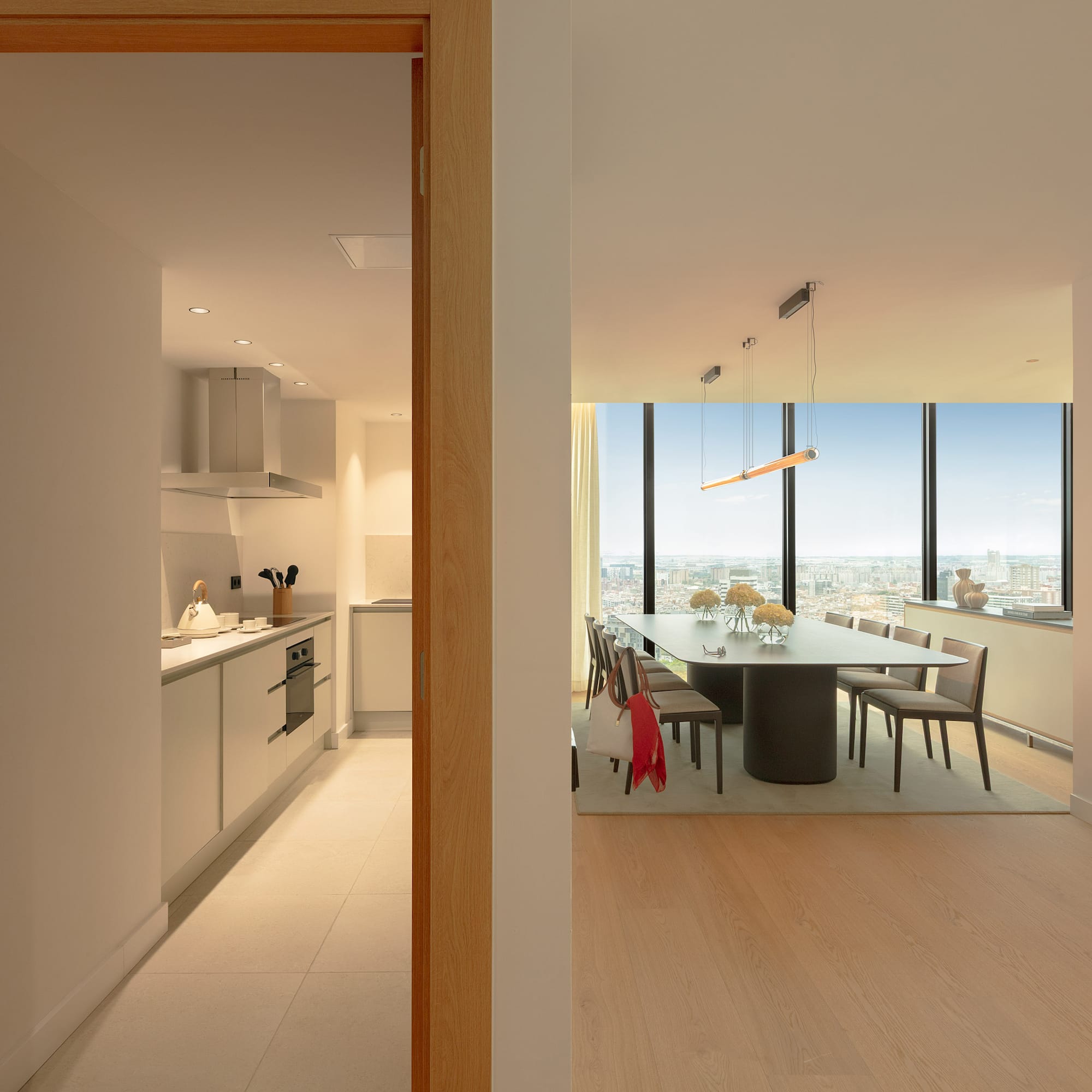 Modern high-rise apartment: open-plan dining room with city view, sleek kitchen.