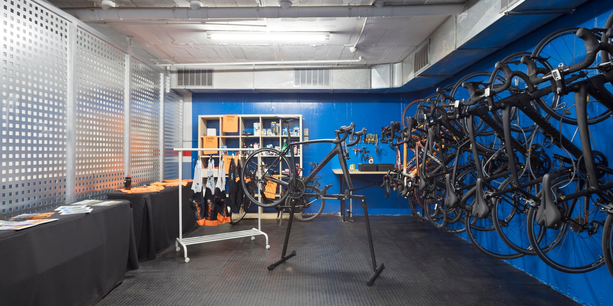 a room with a bike rack and a table with shelves