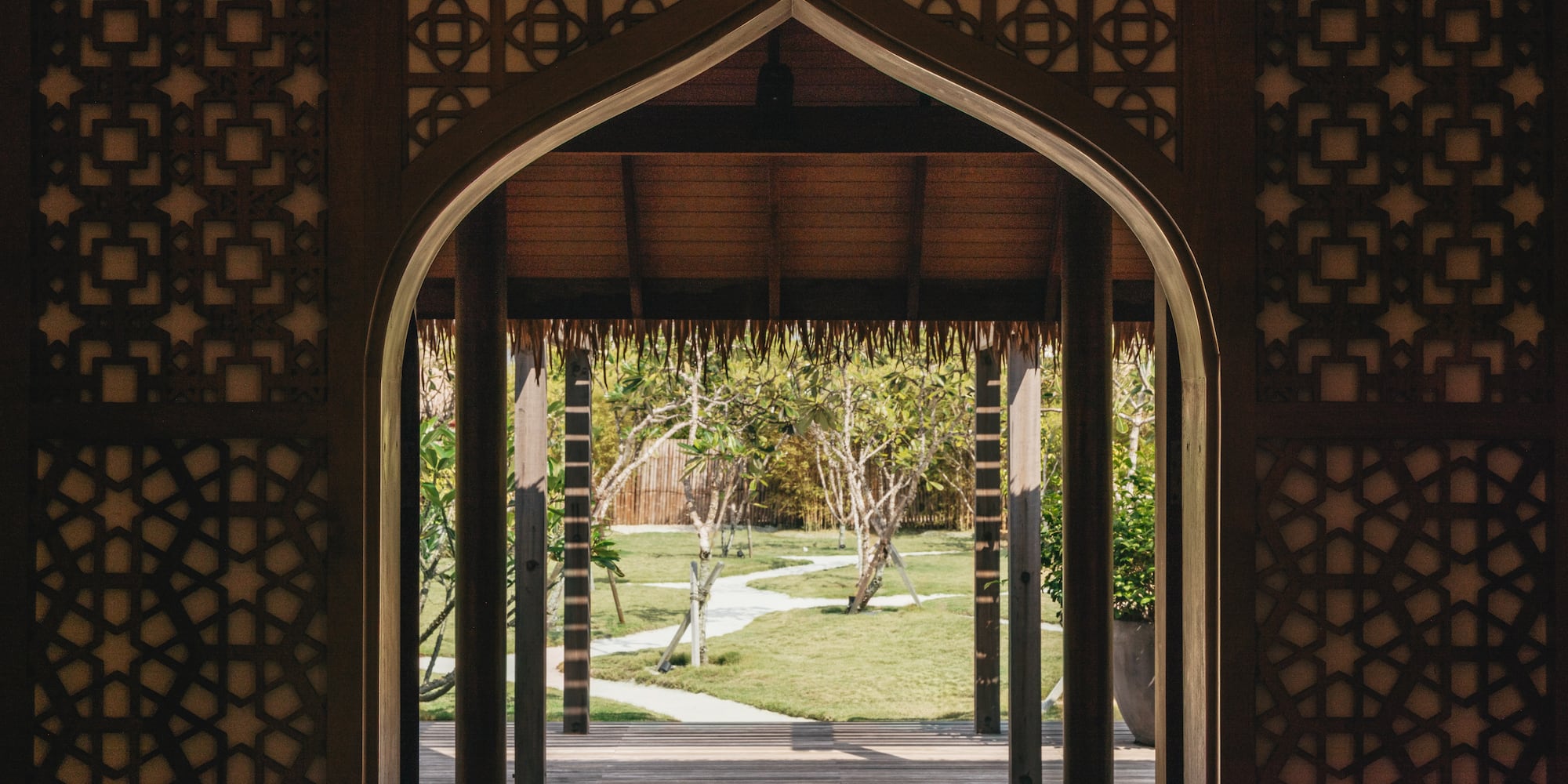 a doorway with a grass covered patio and trees