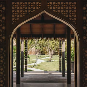 a doorway with a grass covered patio and trees