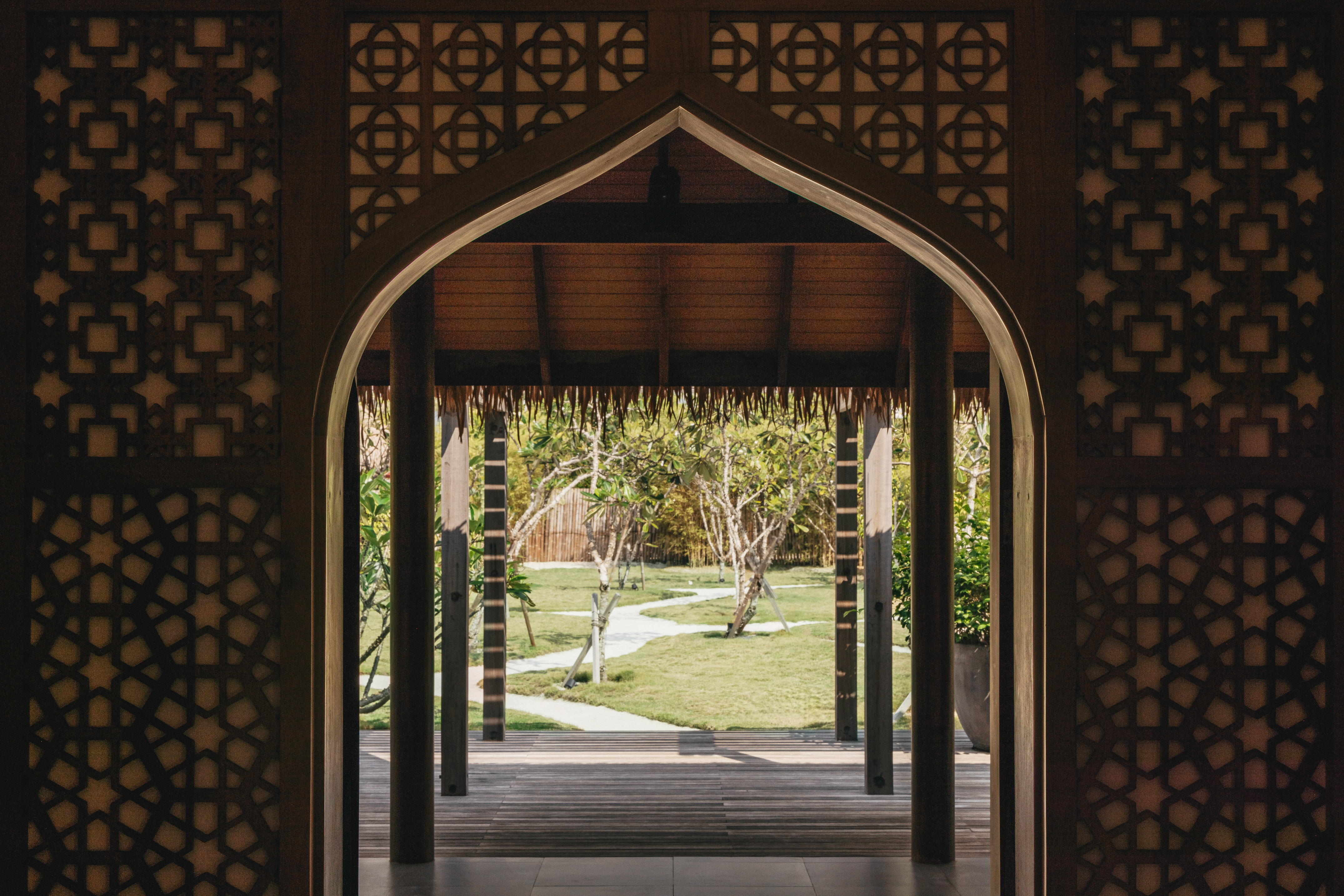 a doorway with a grass covered patio and trees