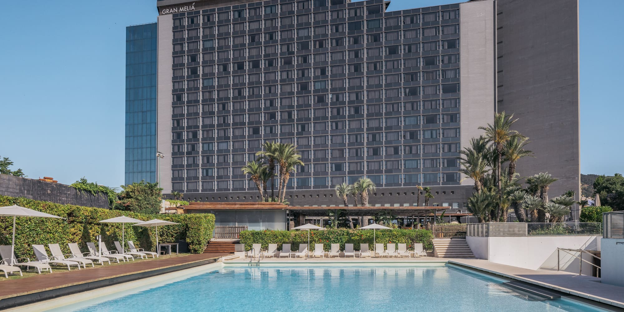 a swimming pool with a large building in the background