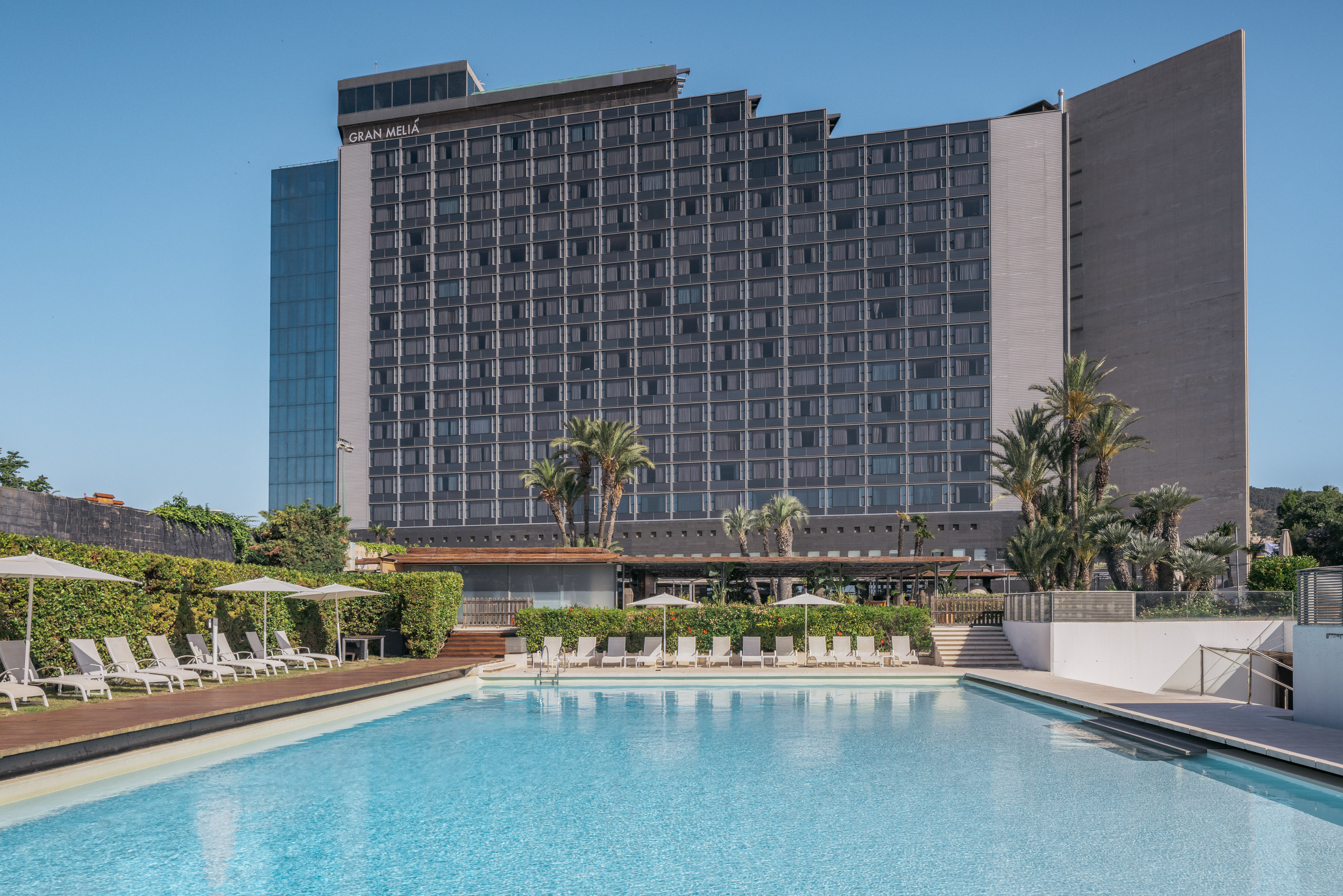 a swimming pool with a large building in the background