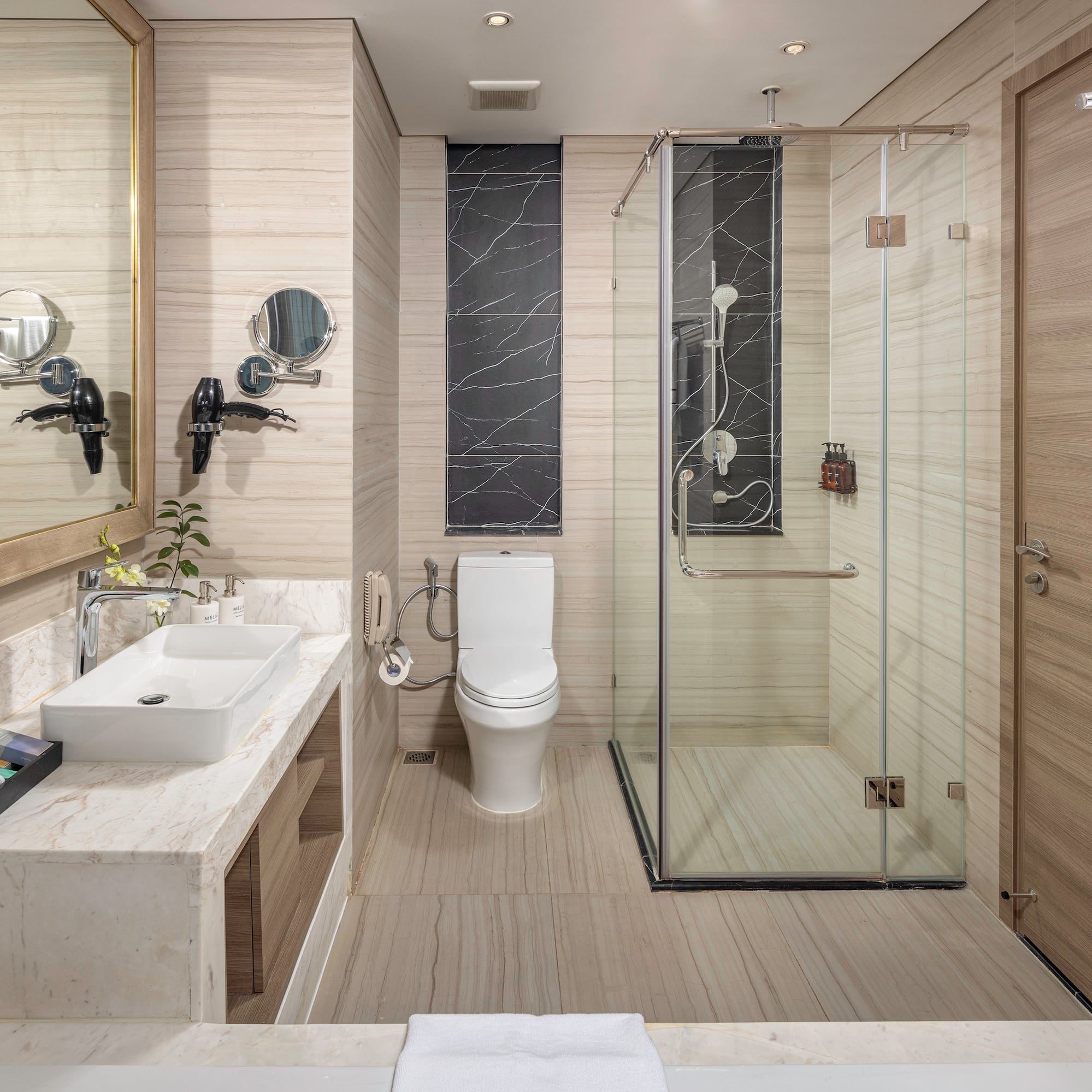 a bathroom with a glass shower and toilet