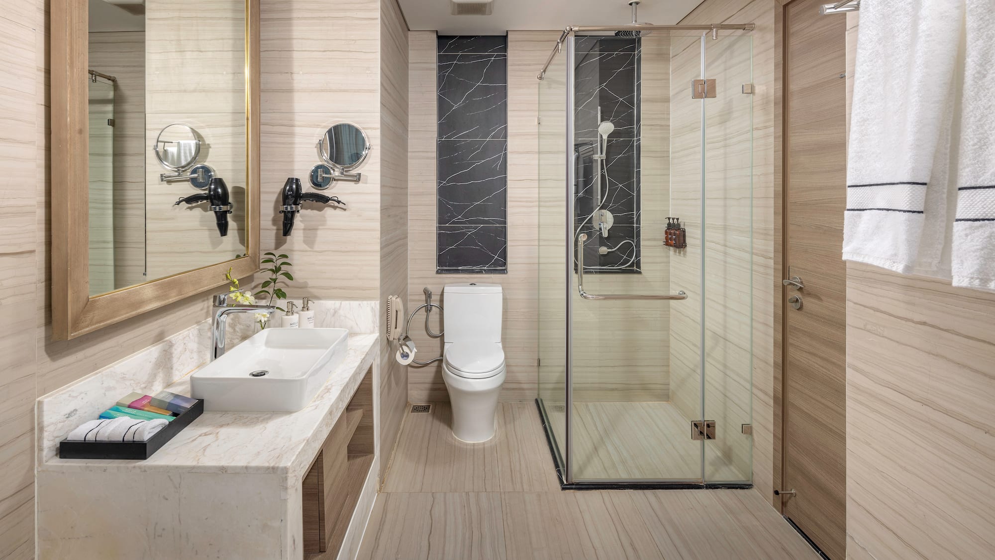 a bathroom with a glass shower and toilet