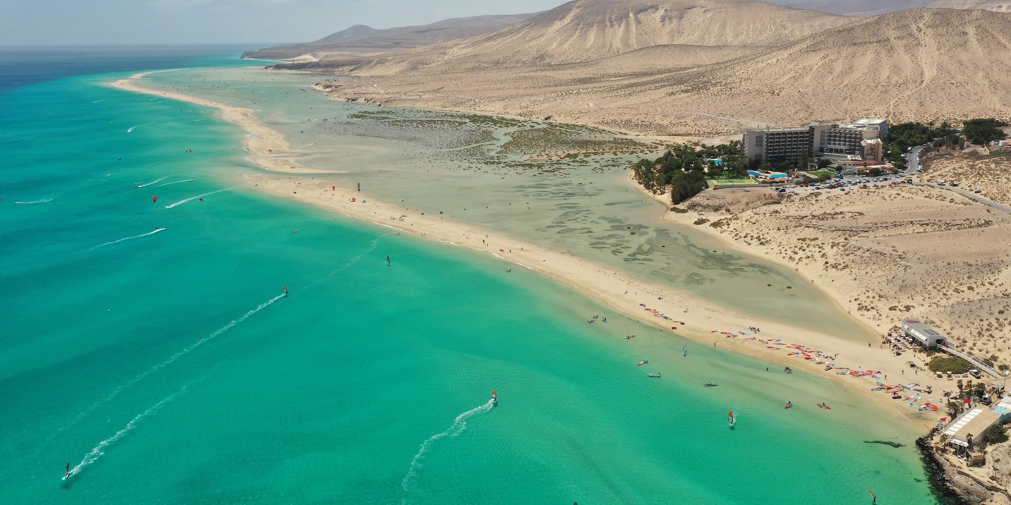 a beach with water and mountains