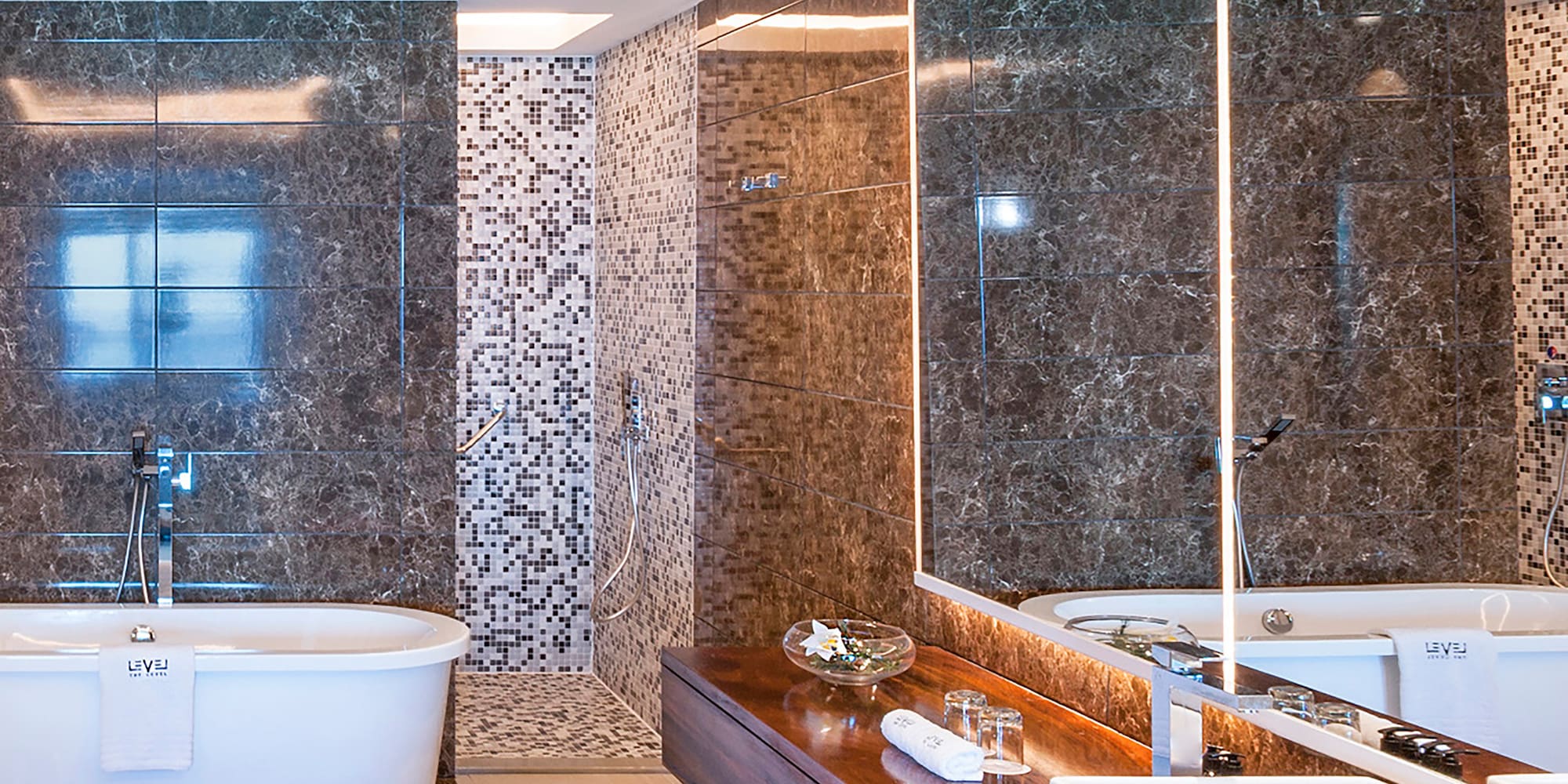 a bathroom with a tub and a large mirror