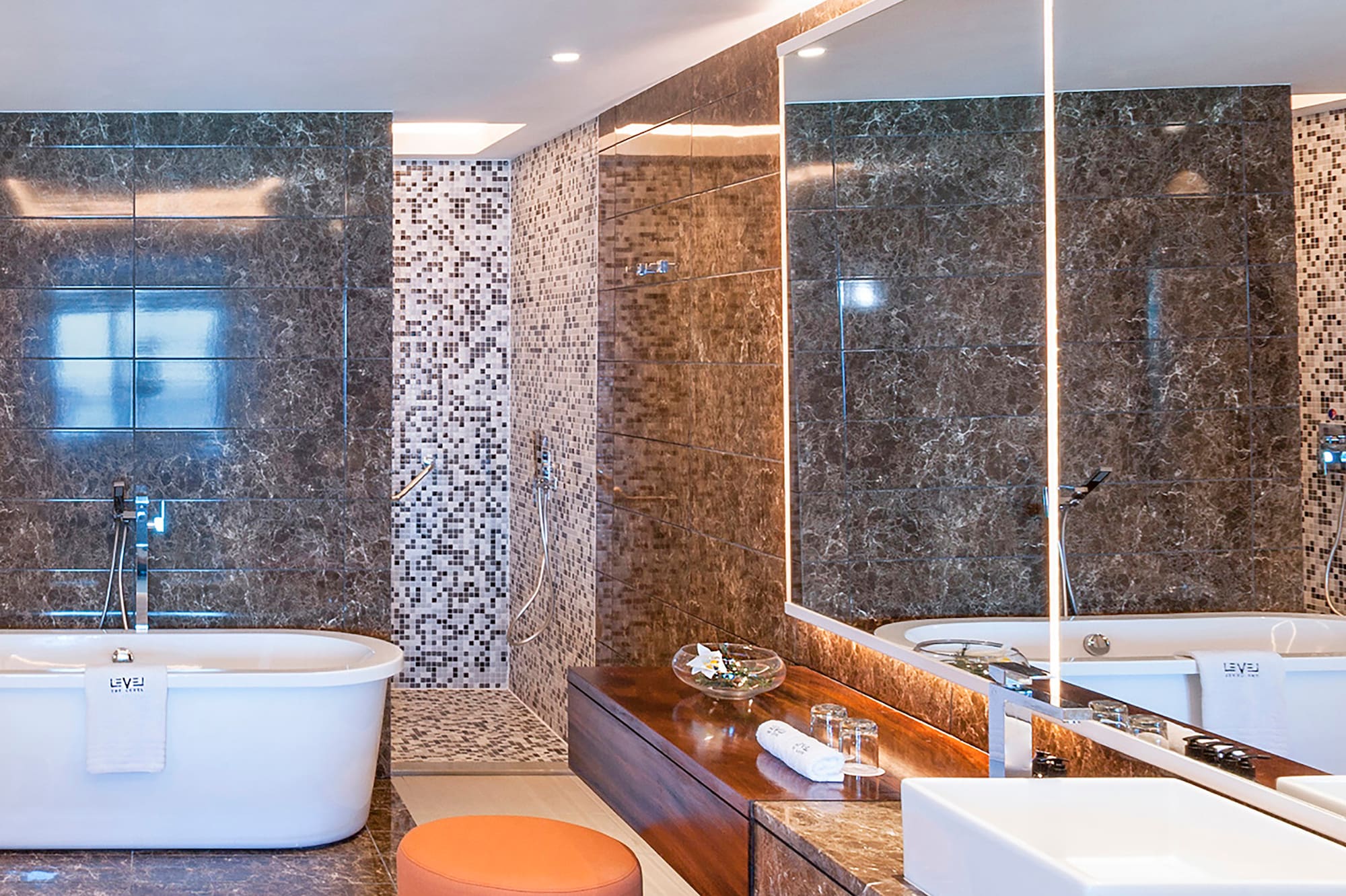 a bathroom with a tub and a large mirror