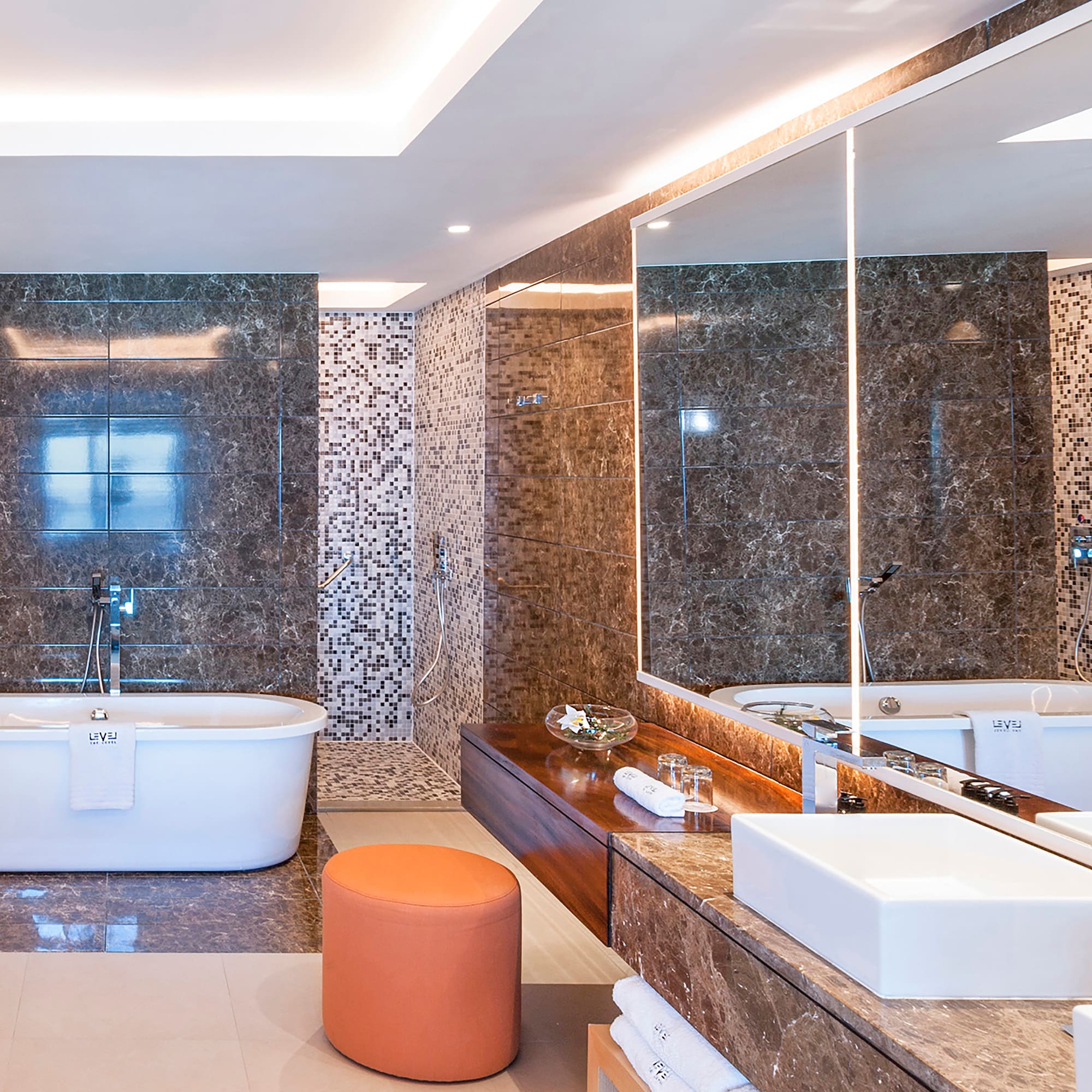 a bathroom with a tub and a large mirror