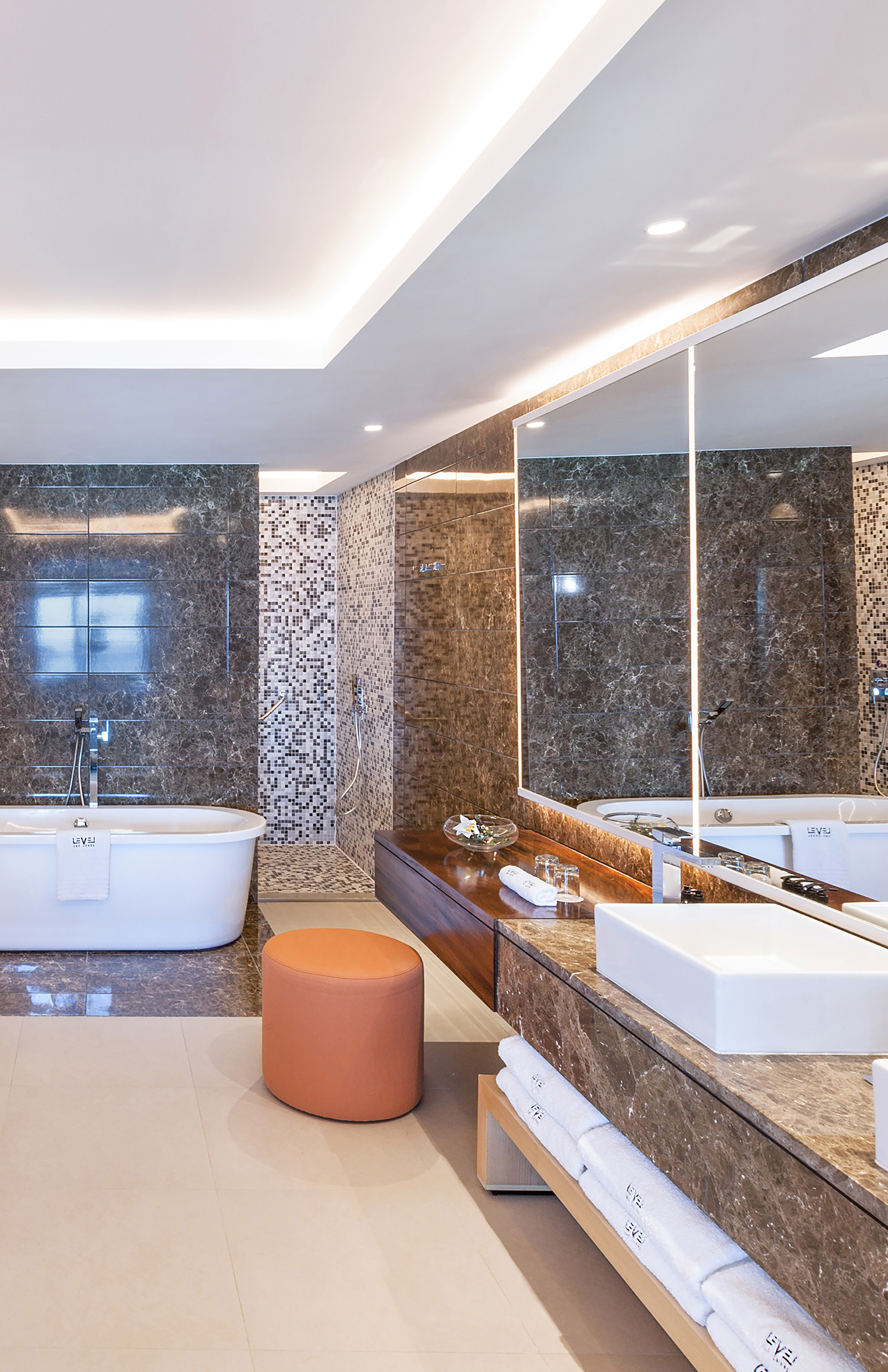 a bathroom with a tub and a large mirror