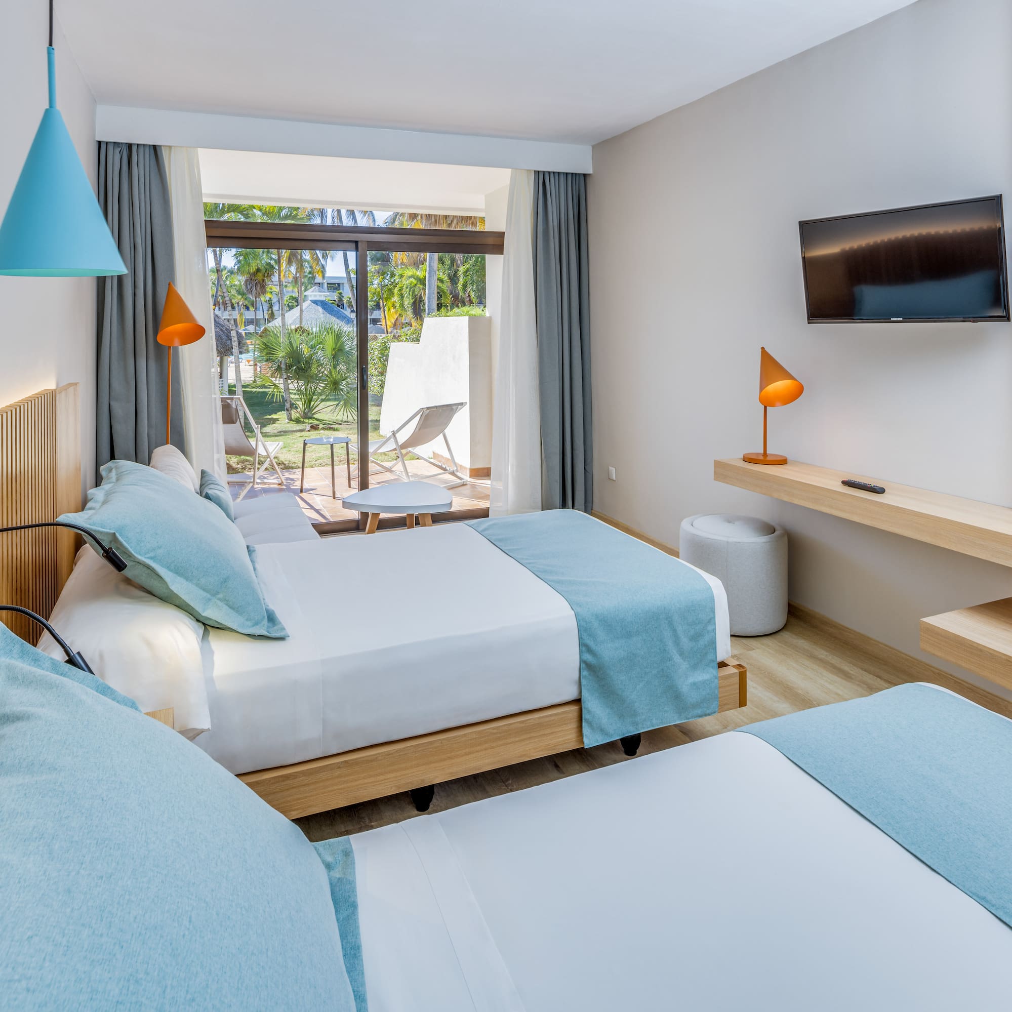 a room with two beds and a television