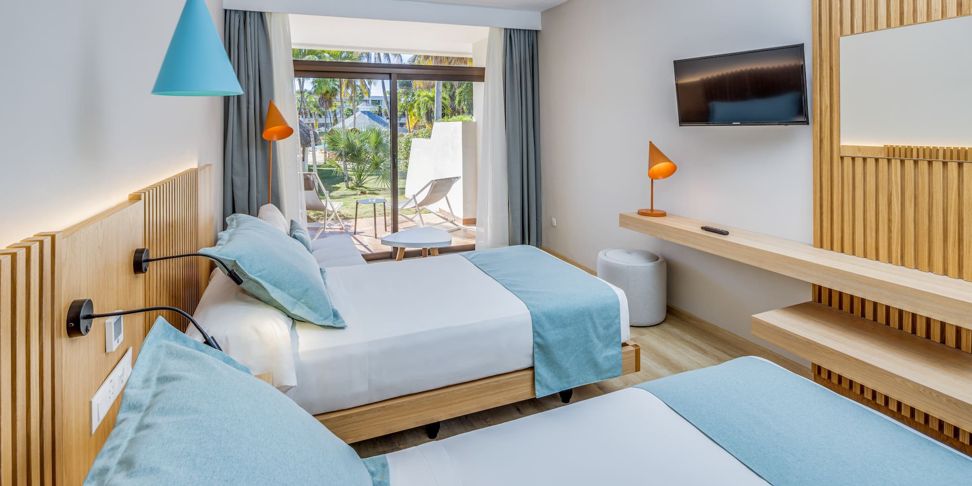 a room with two beds and a television