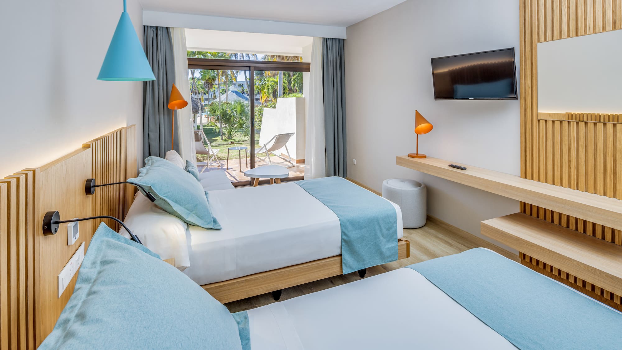 a room with two beds and a television