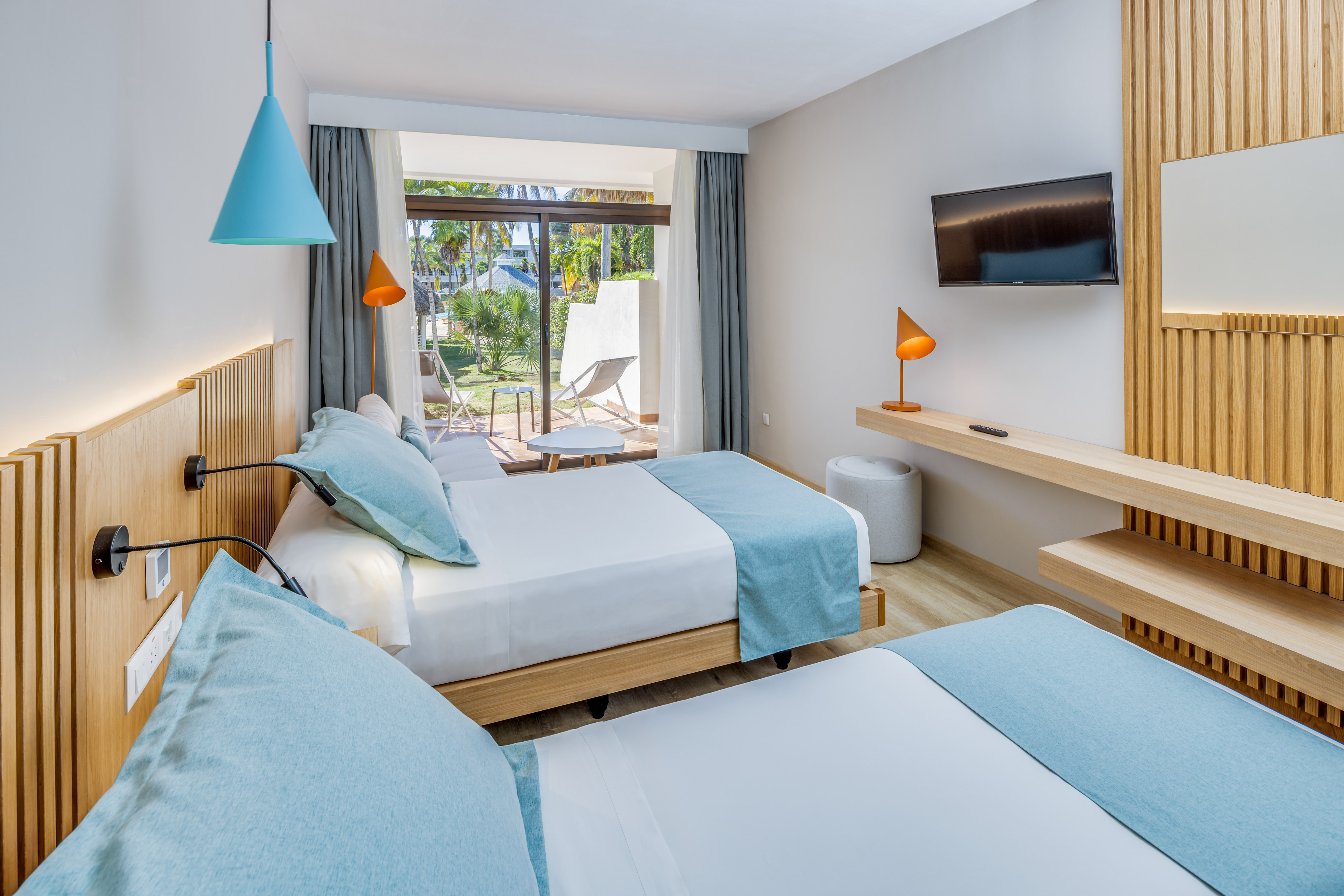 a room with two beds and a television