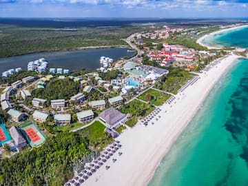 a beach with buildings and a body of water