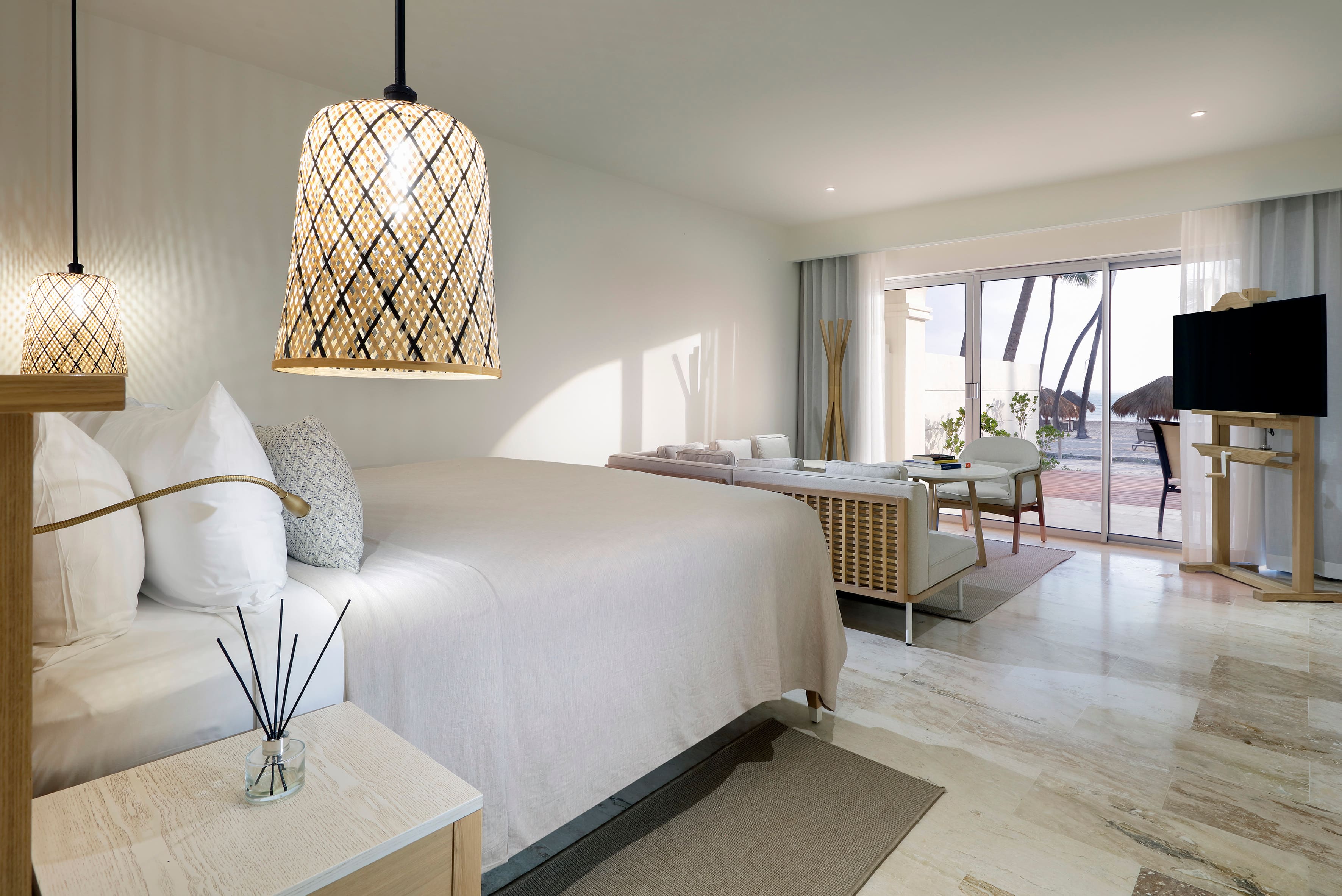 The Reserve Suite Ocean Front at Paradisus Palma Real, with a bedroom and sitting area looking out to the ocean