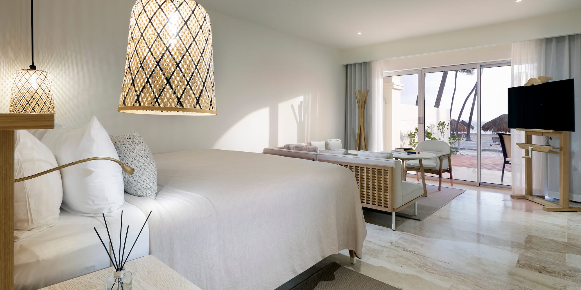 a bedroom with a bed and a table and chairs