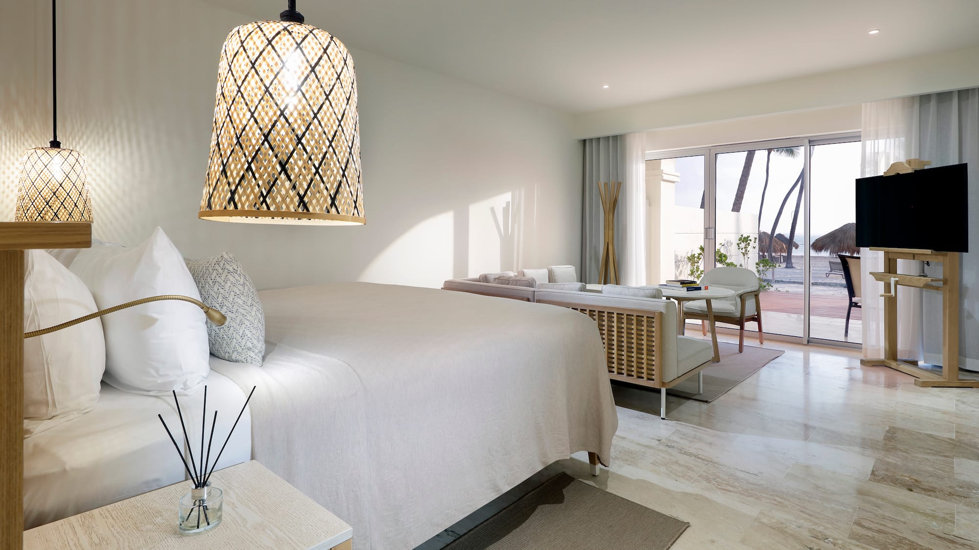 a bedroom with a bed and a table and chairs