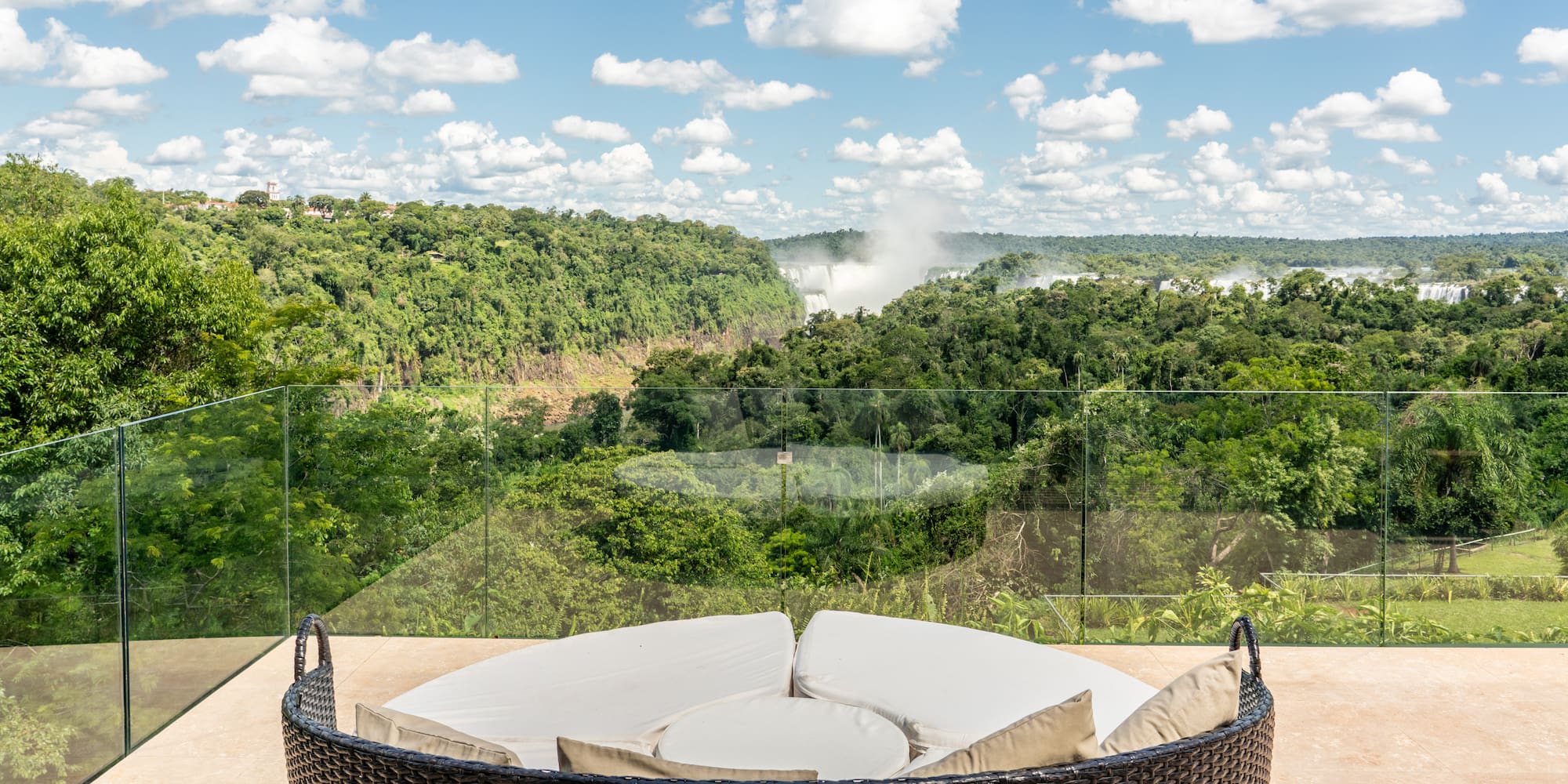 a round chair with a view of a forest