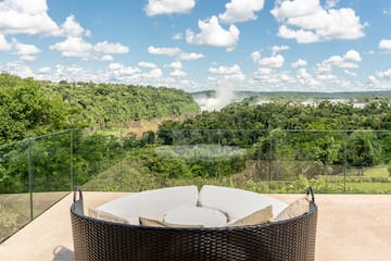 a round chair with a view of a forest