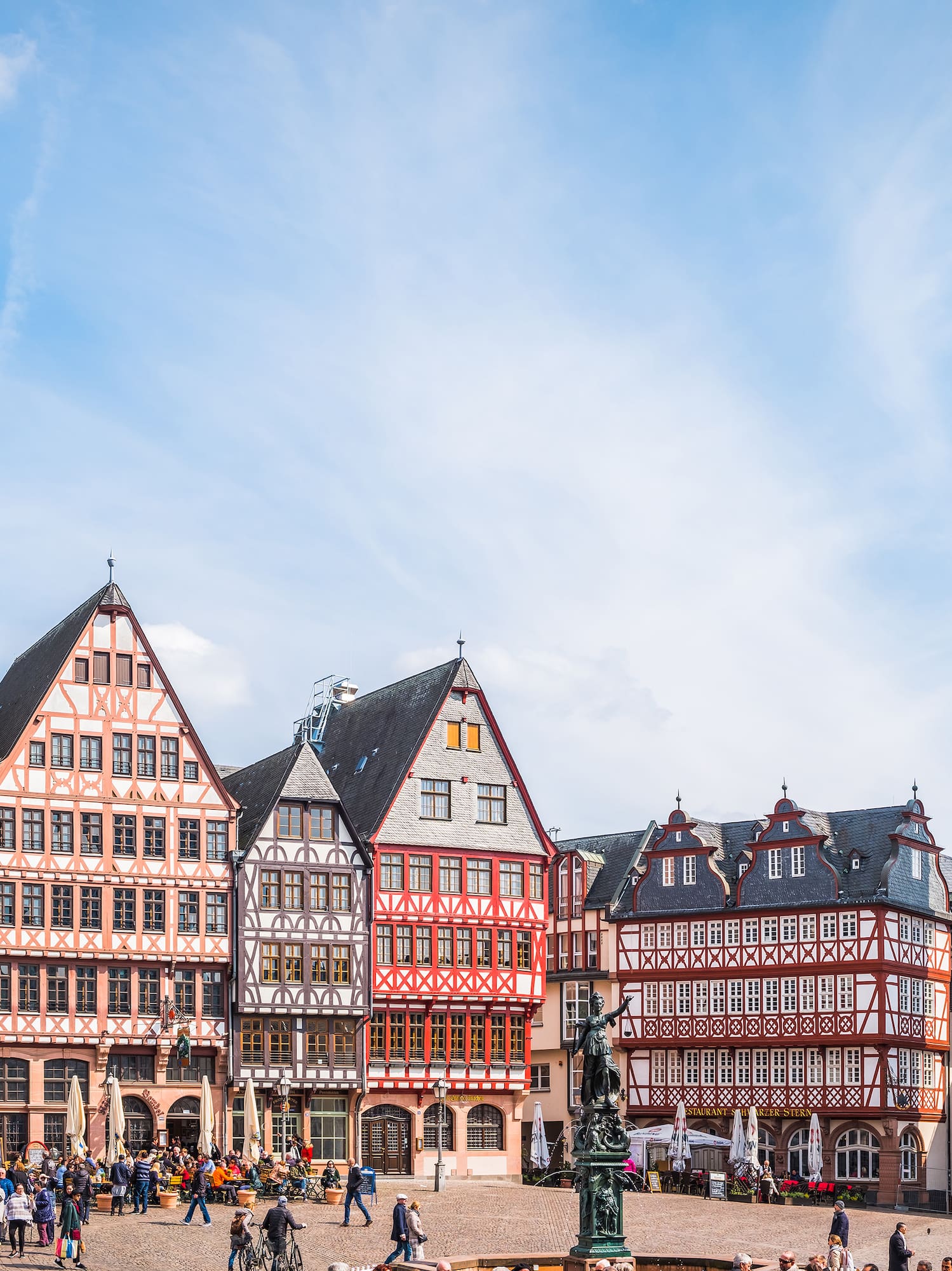 a group of people walking around a city