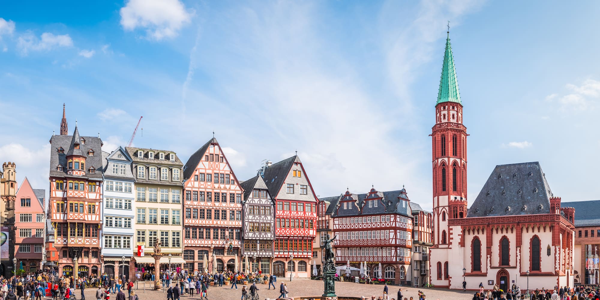 a group of people walking around a city