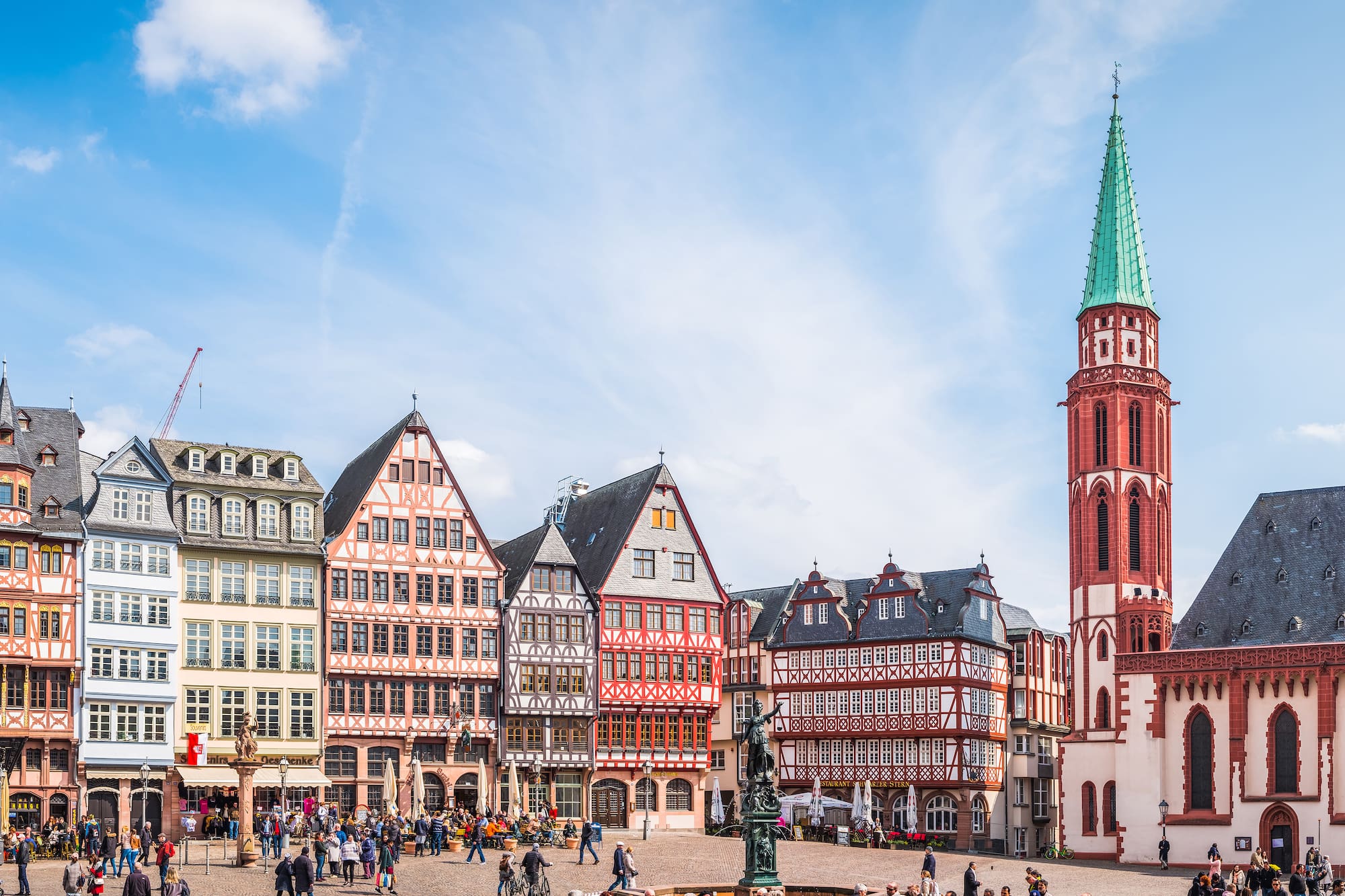 a group of people walking around a city