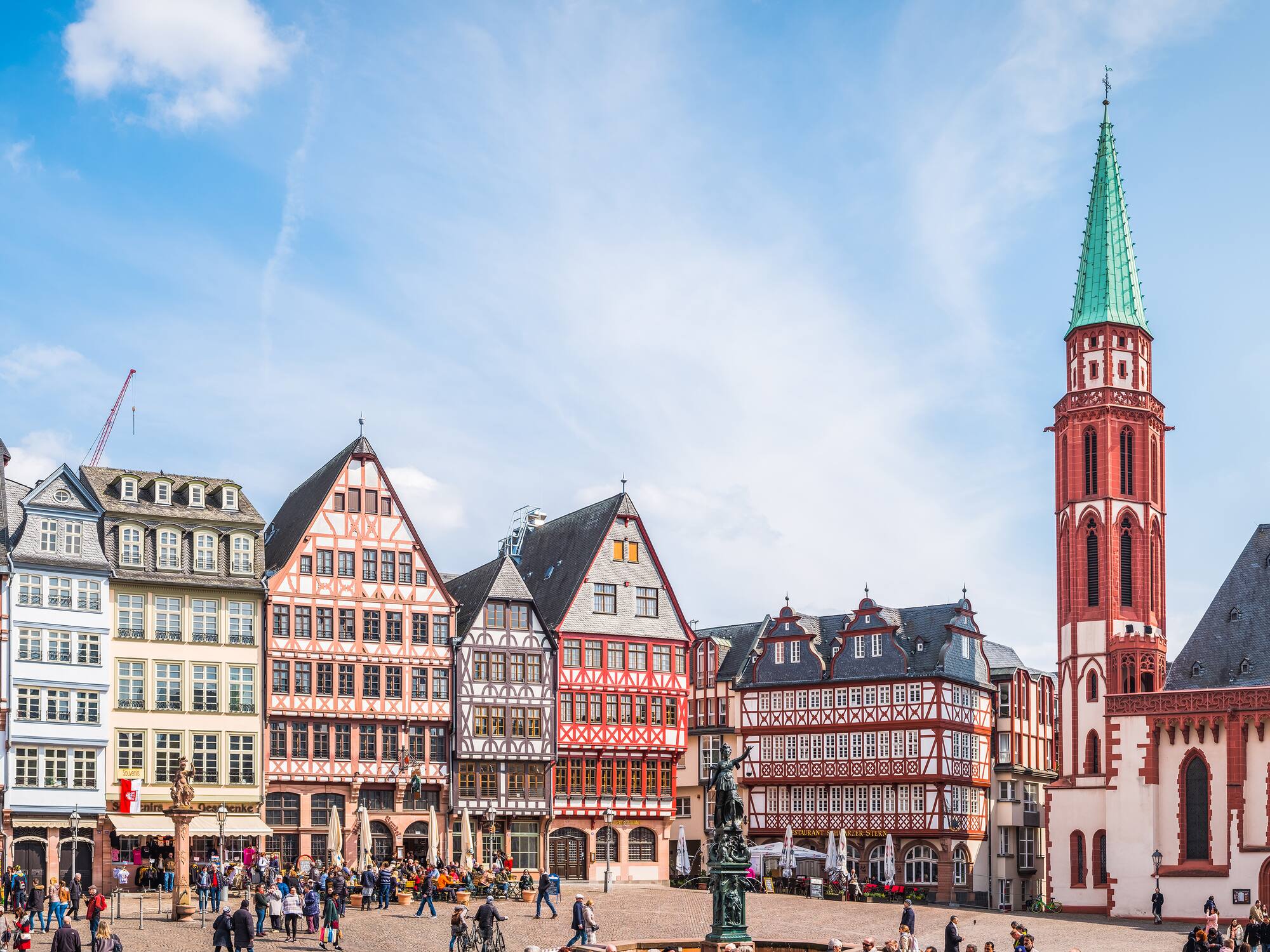 a group of people walking around a city