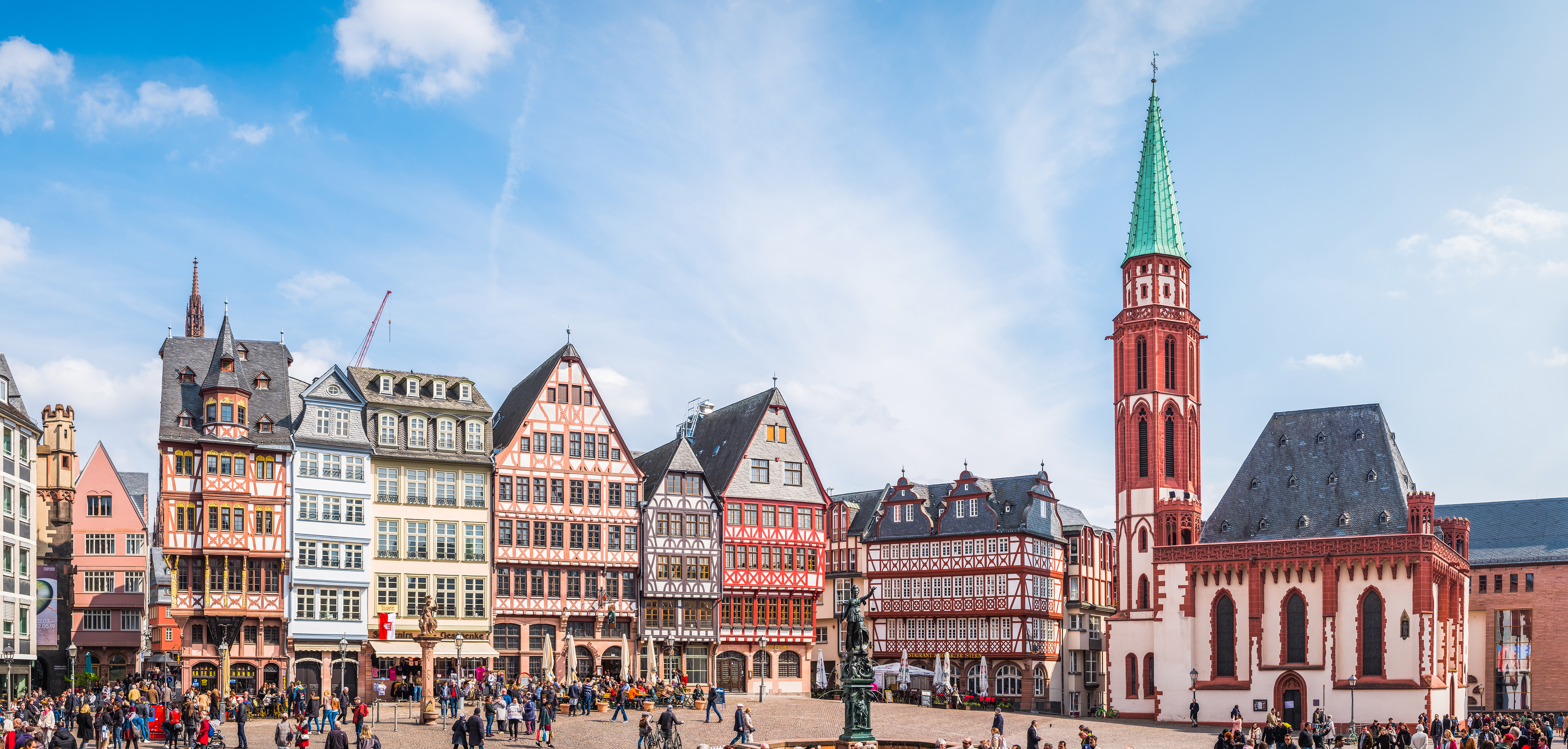 a group of people walking around a city