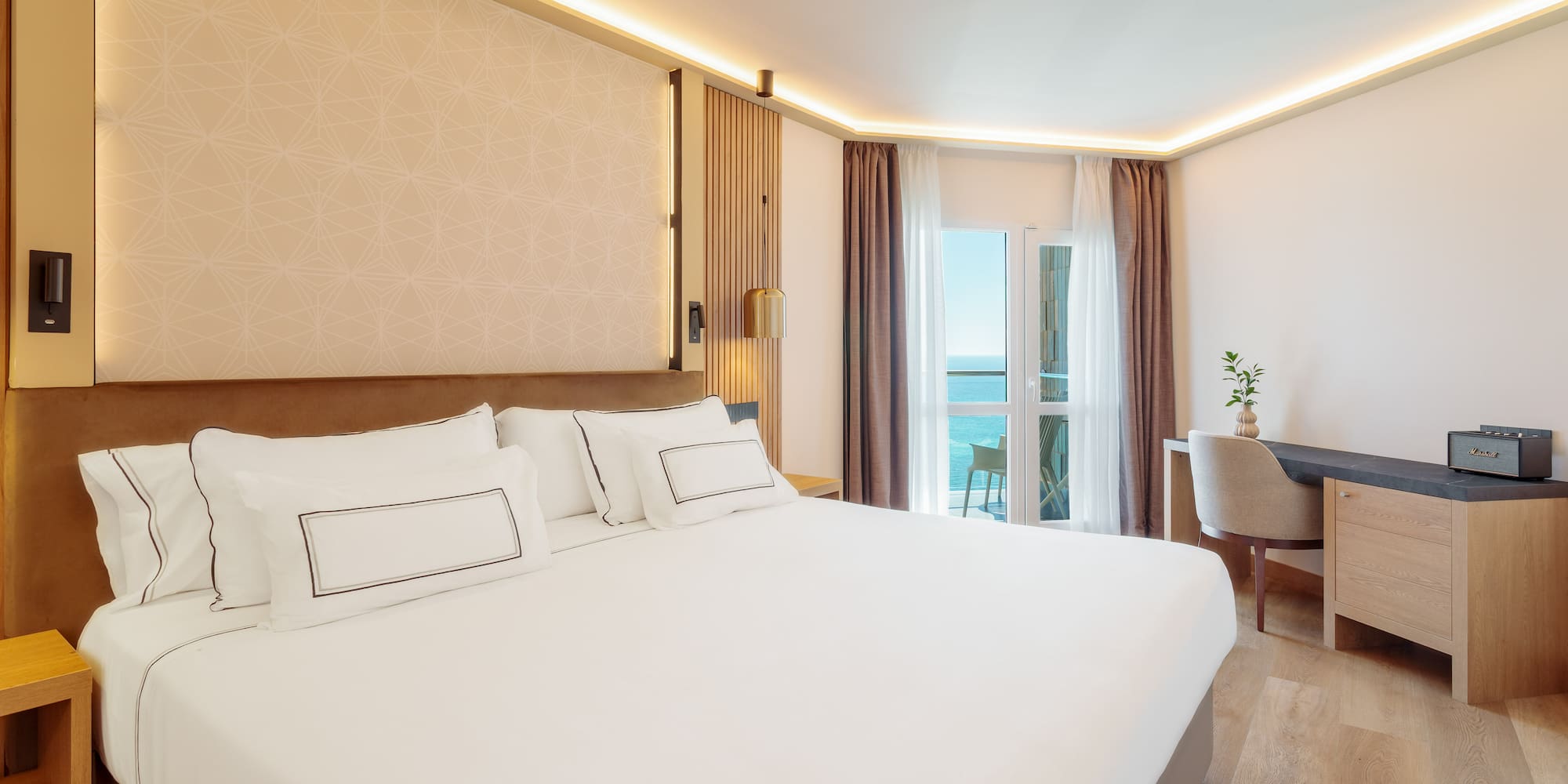 a room with a bed and a desk and chair