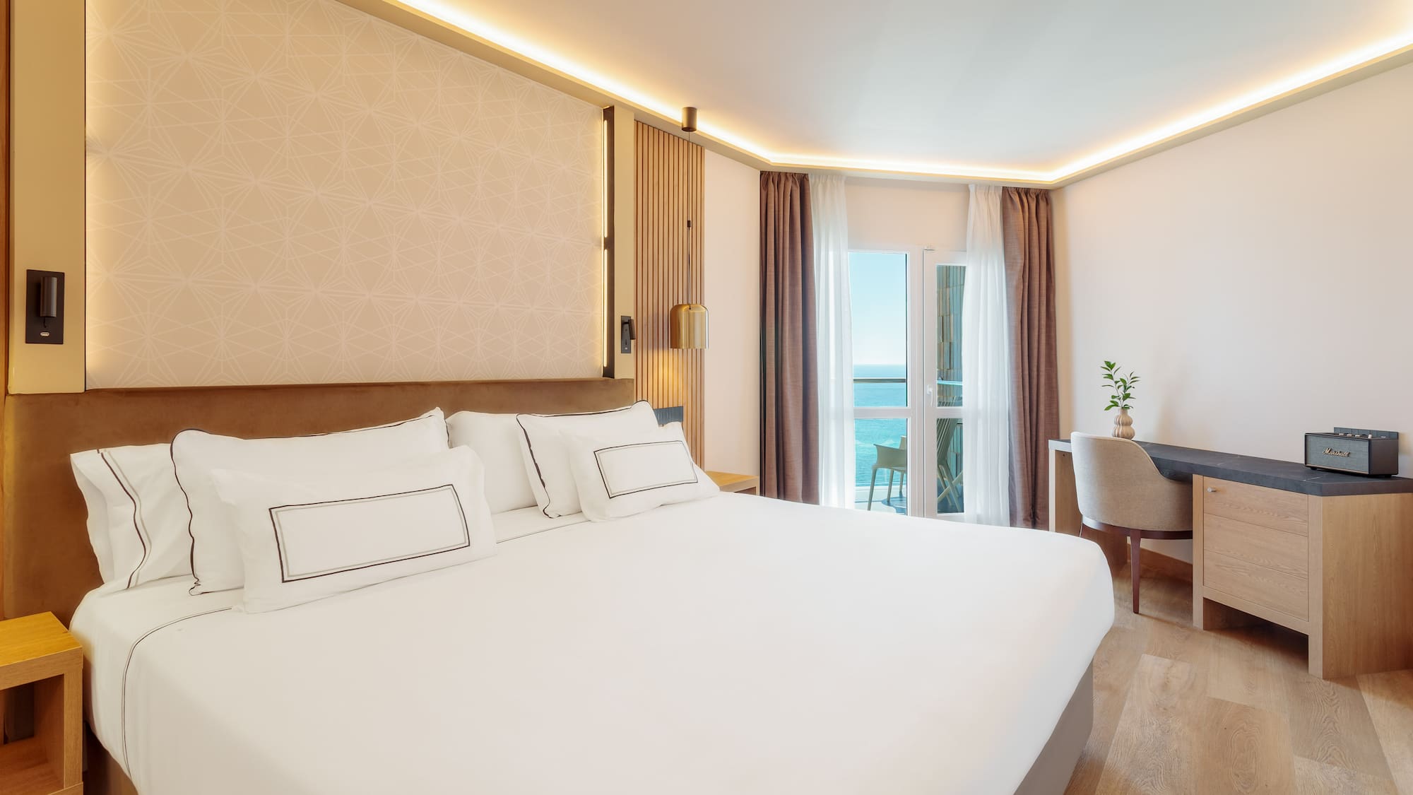 a room with a bed and a desk and chair