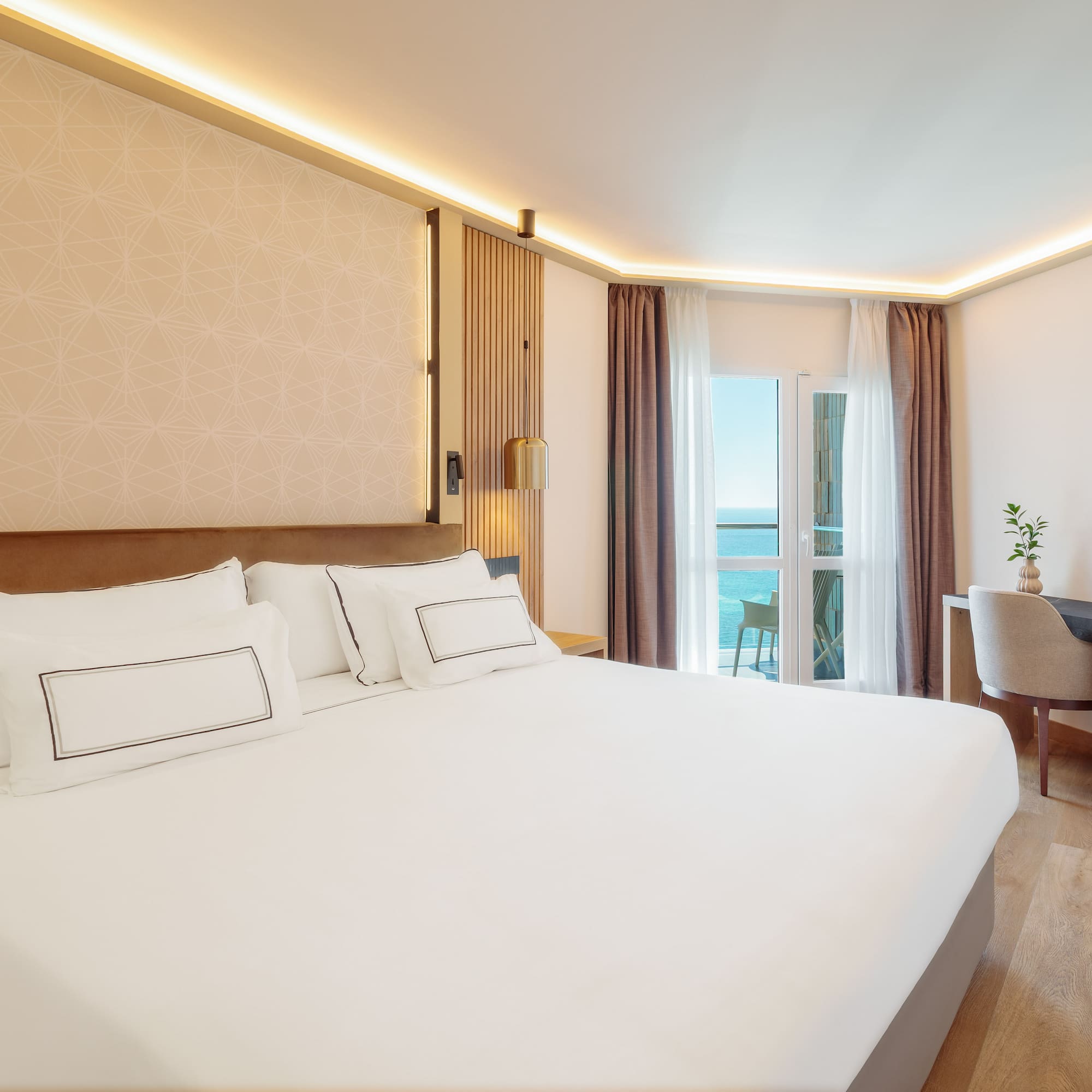 a room with a bed and a desk and chair