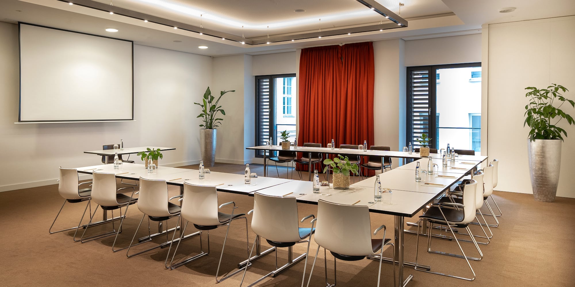 a room with white tables and chairs