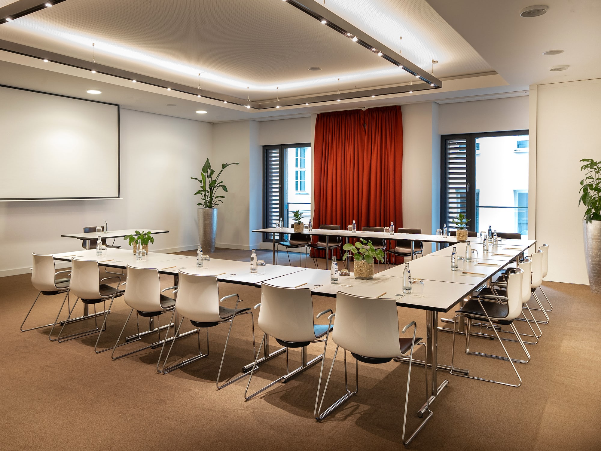 a room with white tables and chairs