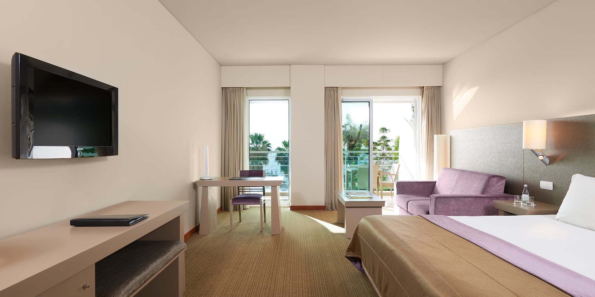 a room with a bed and a television