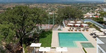 a pool and a pool with umbrellas and chairs