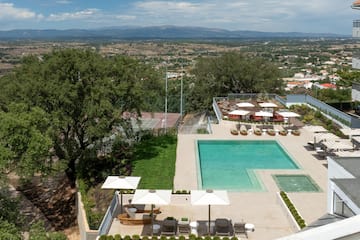 a pool and a pool with umbrellas and chairs