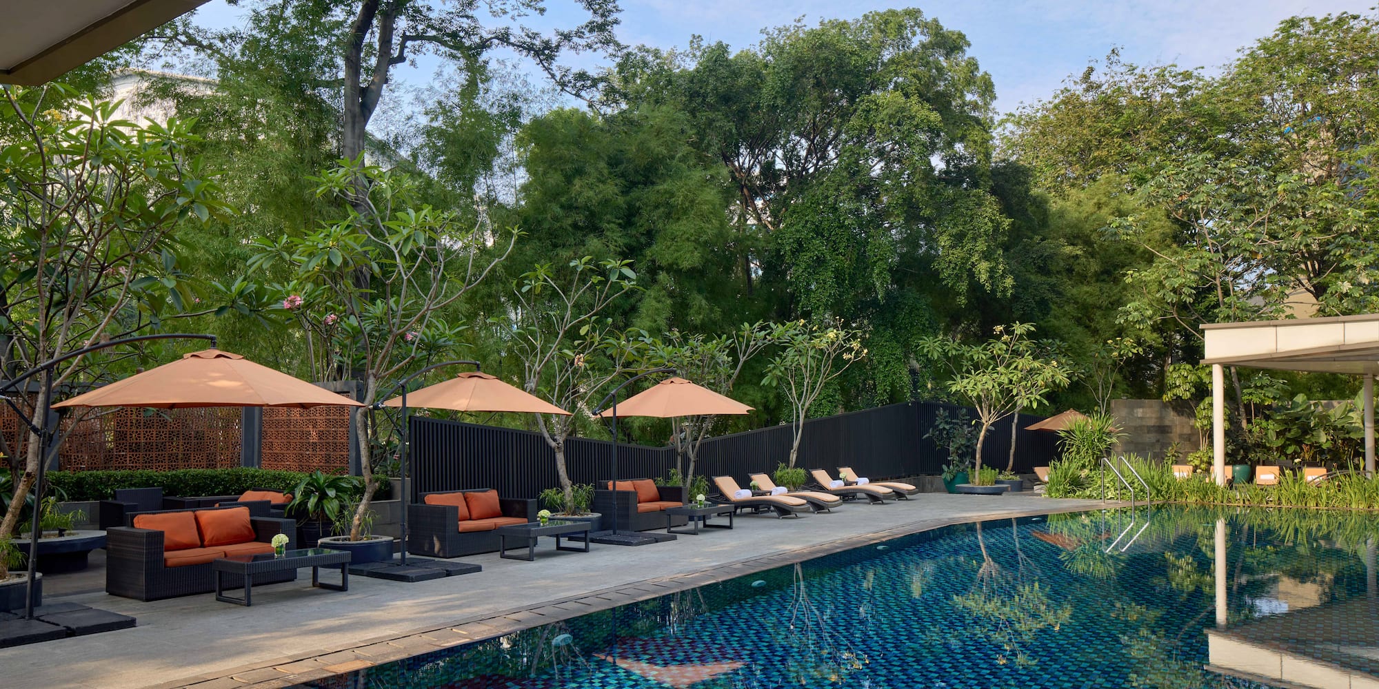 a pool with chairs and umbrellas