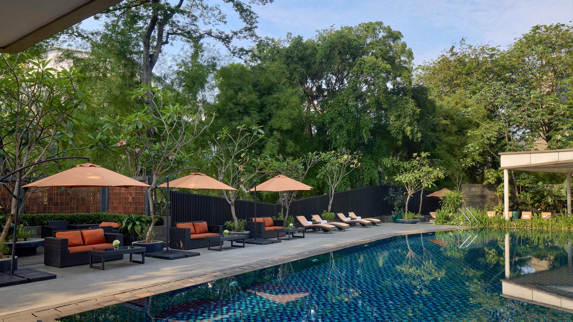 a pool with chairs and umbrellas
