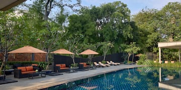 a pool with chairs and umbrellas